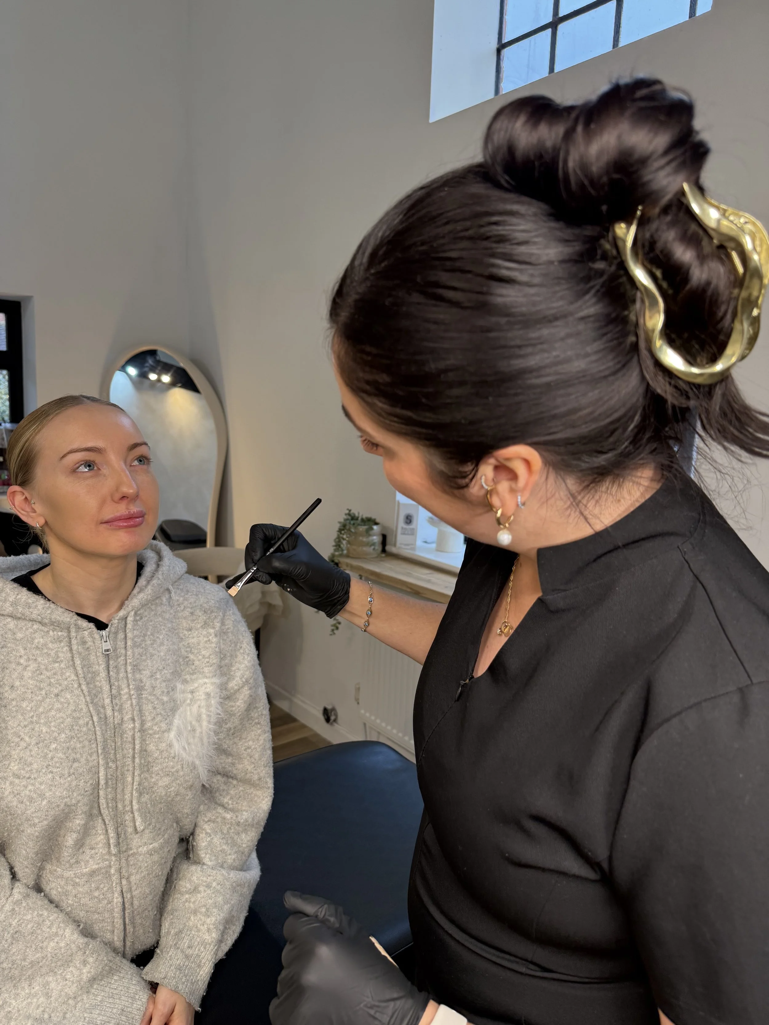 Katie performing a Lip Blush treatment at KMS Brows & Beauty in Reading, Berkshire, carefully applying semi-permanent pigment to the lips.