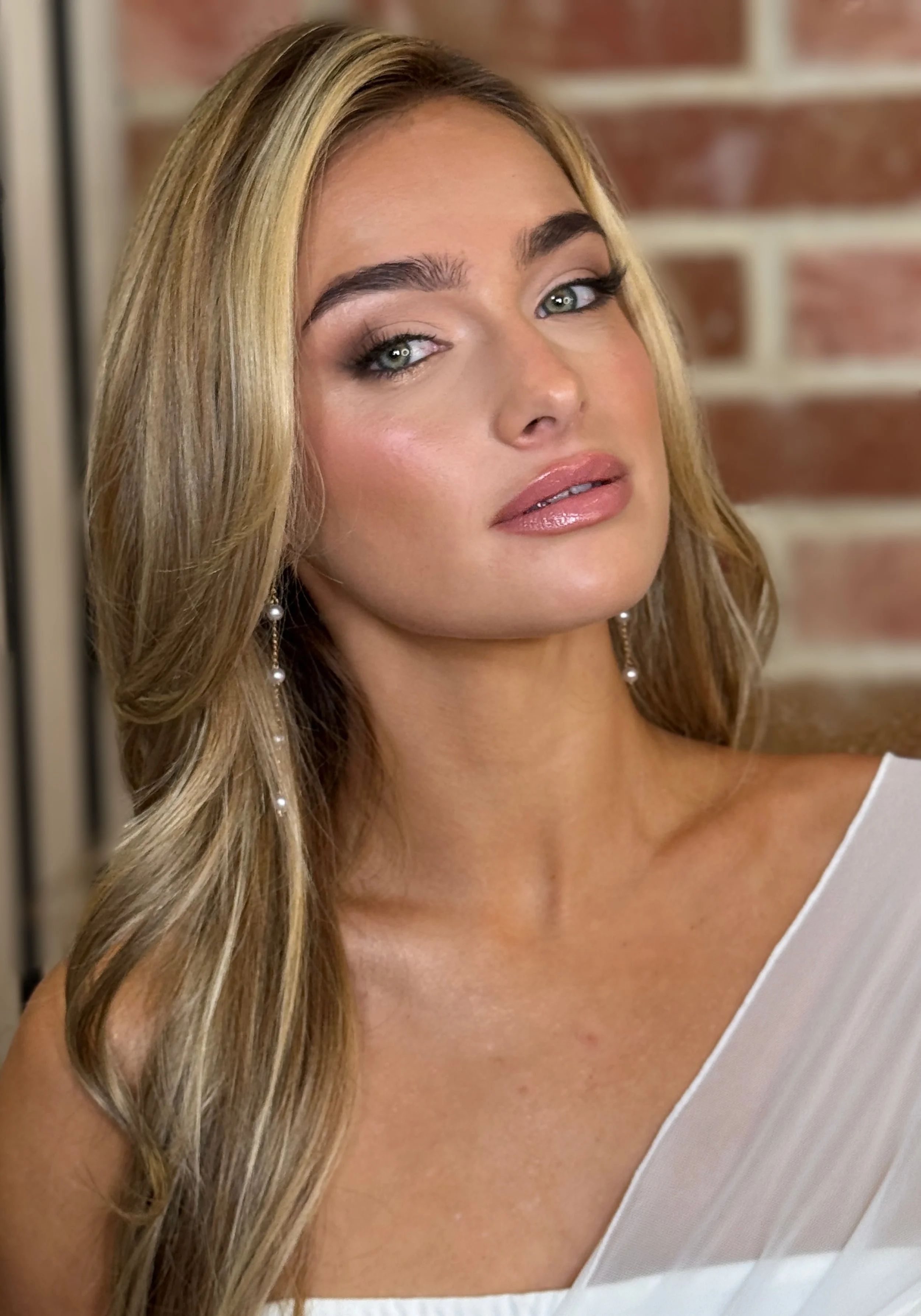 Peach soft glam makeup look featuring radiant, glowing skin, subtly defined eyes, and a polished, natural lip, professionally applied by Katie of KMS Brows & Beauty