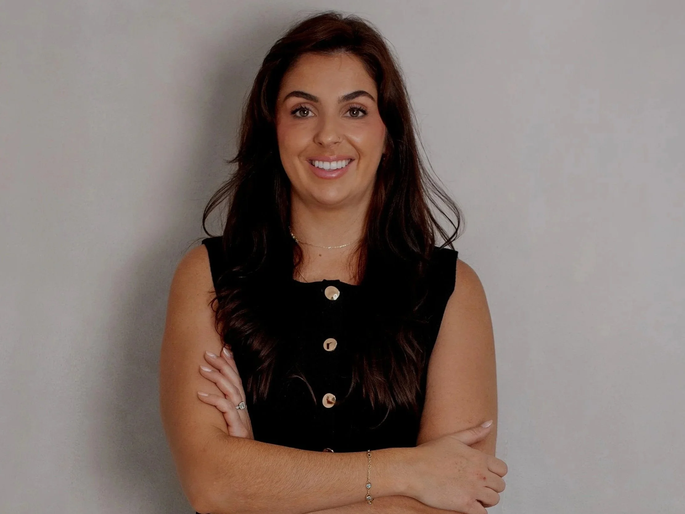 Professional portrait of Katie, founder of KMS Brows & Beauty, smiling confidently on the Book Now page, representing expertise in bridal makeup, semi-permanent makeup, and aesthetic beauty services.