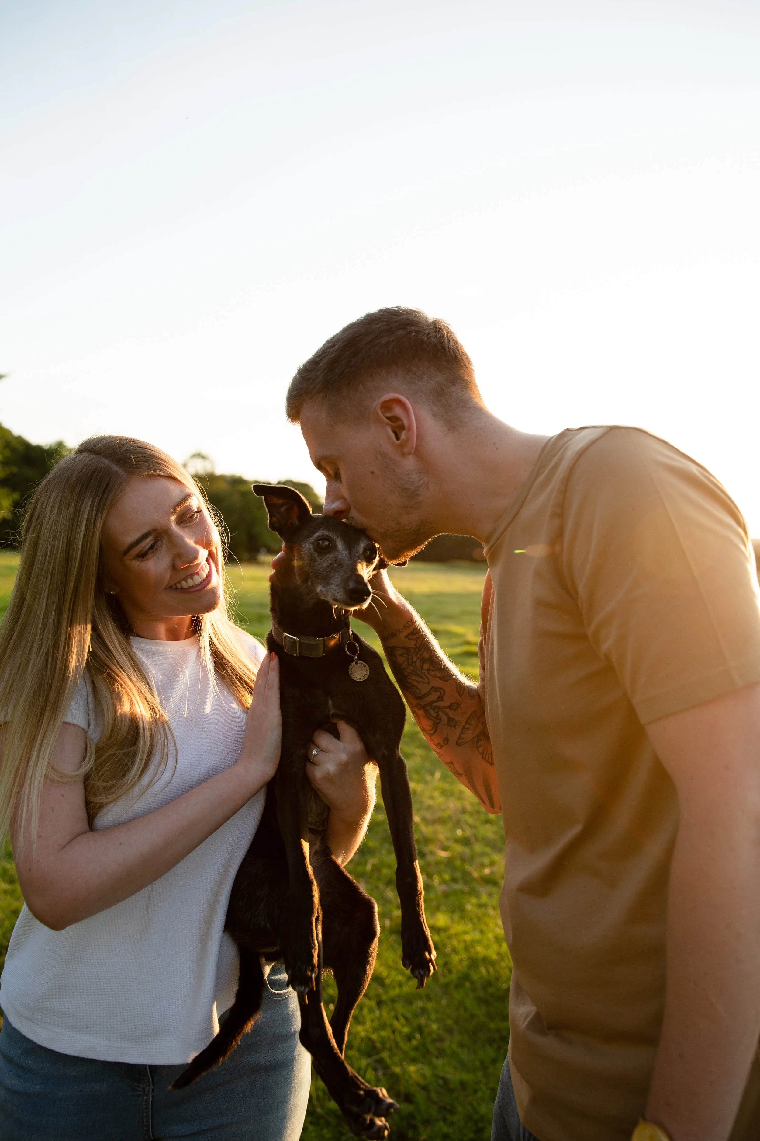 A couple at sunset with their dog