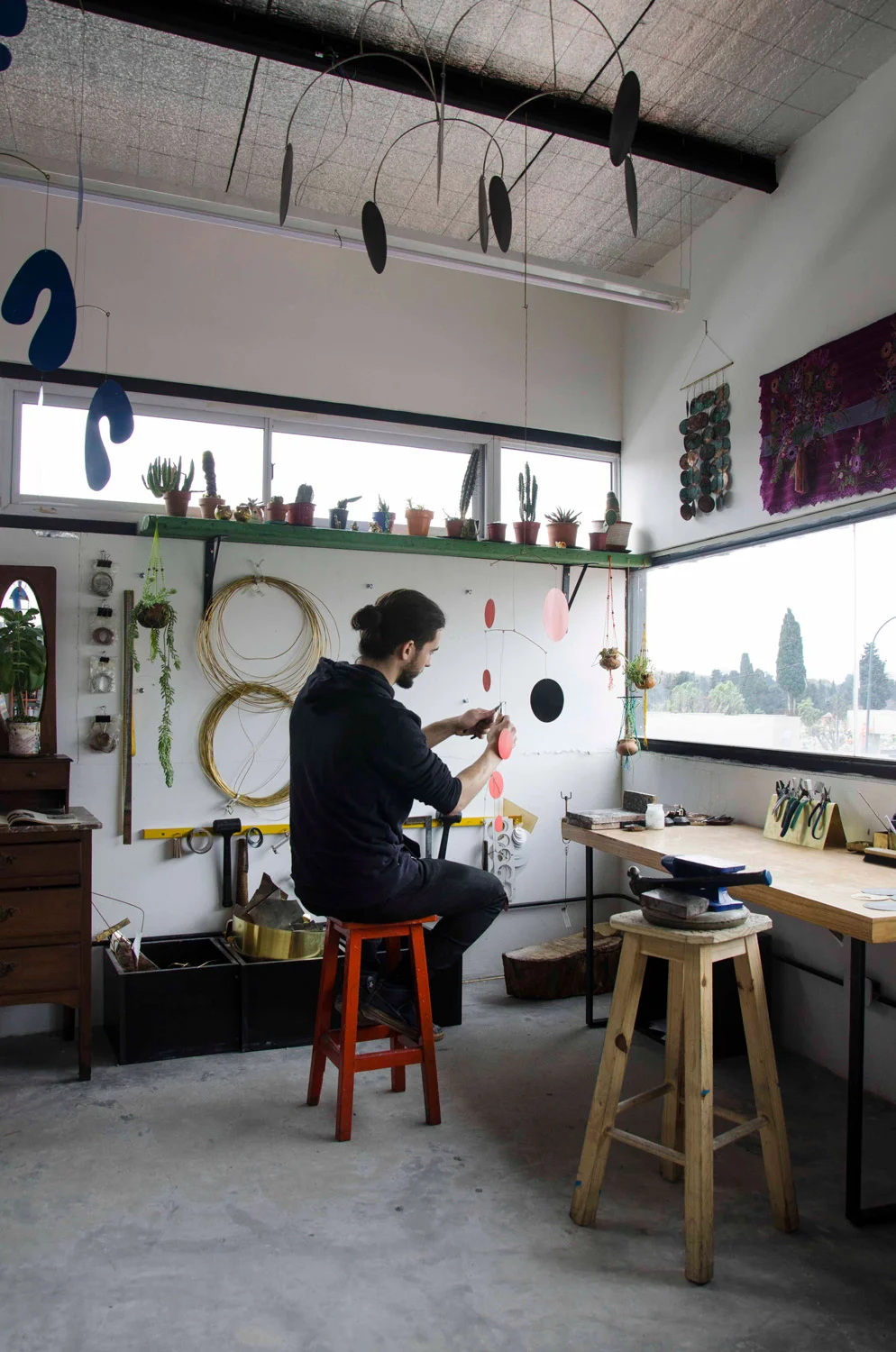 Fernanda’s nephew Julian, a member of the design team, constructs a mobile from the SS19 collection.