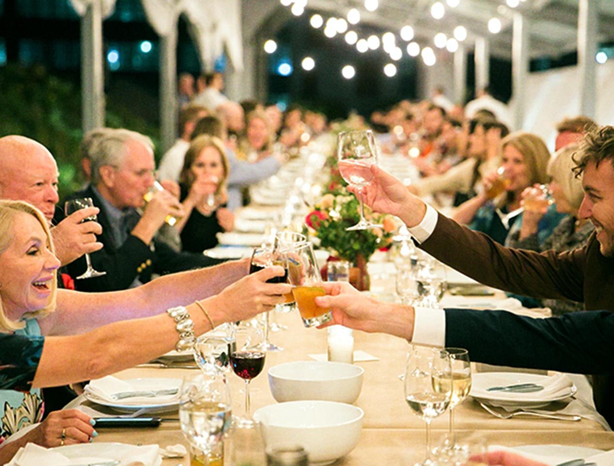 Wedding guests raise their glasses for a toast at the Brooklyn Grange.