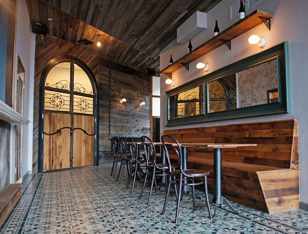 Interior of Fitzcorraldo ready for opening with bar off to the left and tables in the foreground.