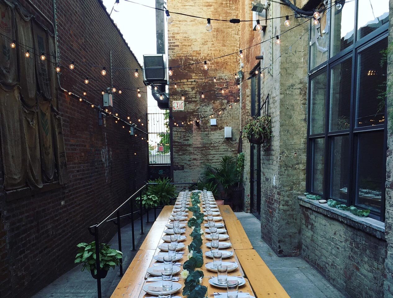 Exterior of Fitzcorraldo set up for an event with a long dining table ready for attendees. 