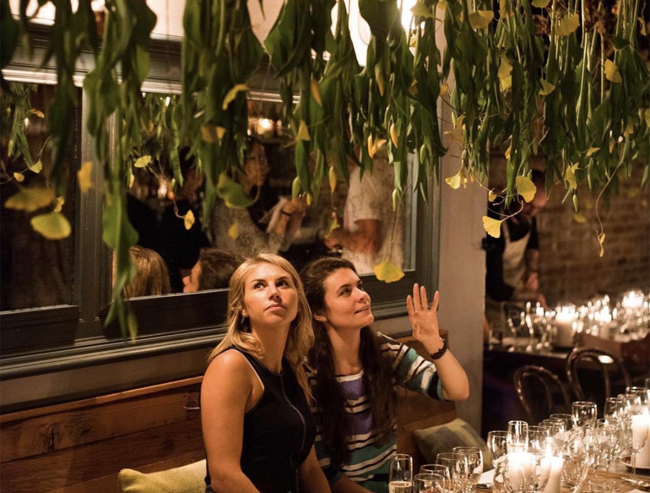 Two guests look up at the floral arrangements at Silo NYC.