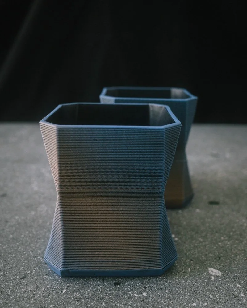 2 3D printed blue and black angular cups