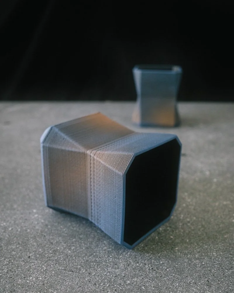 2 3D printed blue and black angular cups