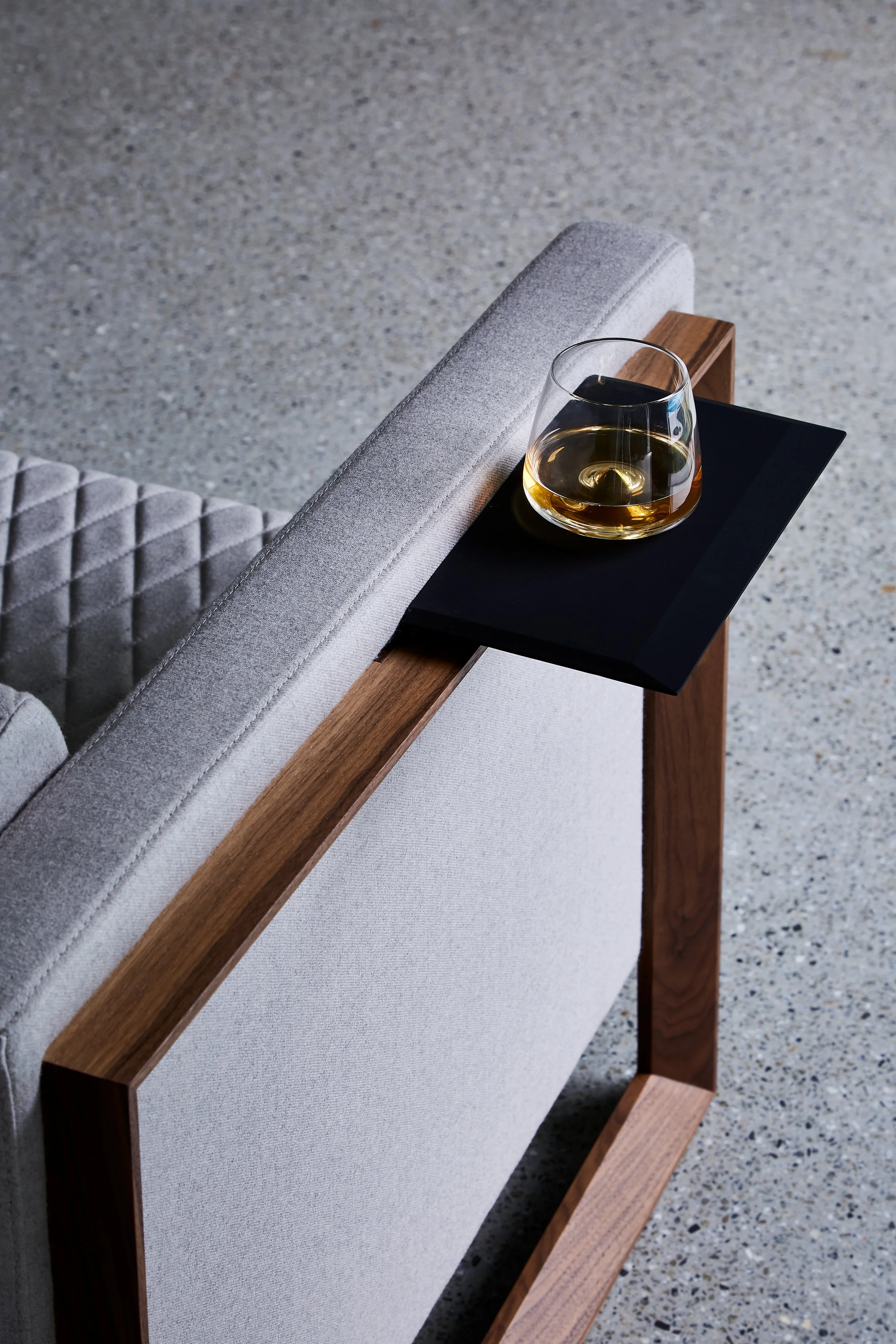 The chamfered timber legs of the Mena armchair.