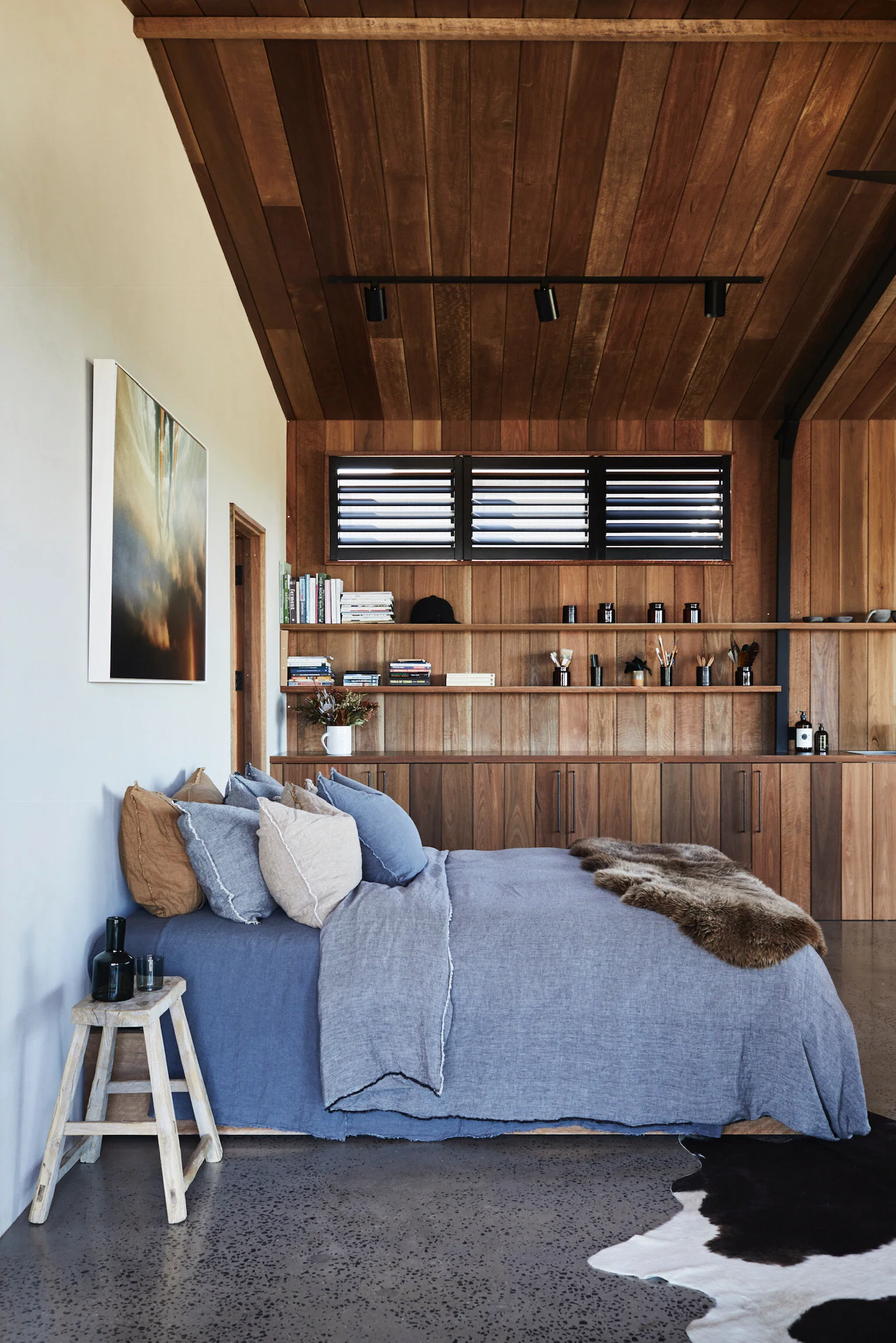Textural heaven with timber, concrete and linen dominating one of the bedroom spaces. Photo - Alicia Taylor Photography.