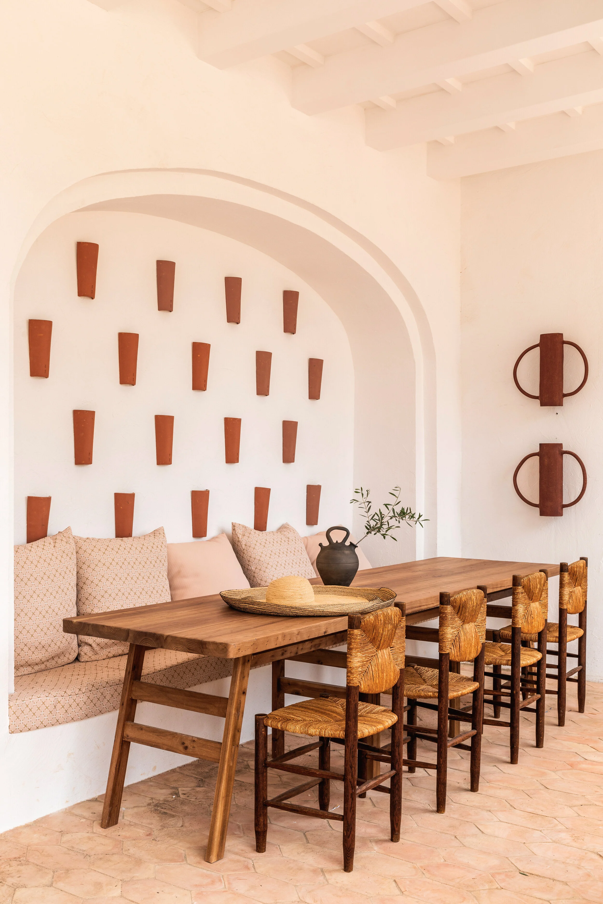 Stone-tiled floors, arched alcoves with feature banquette seating in a quiet corner of the hotel.