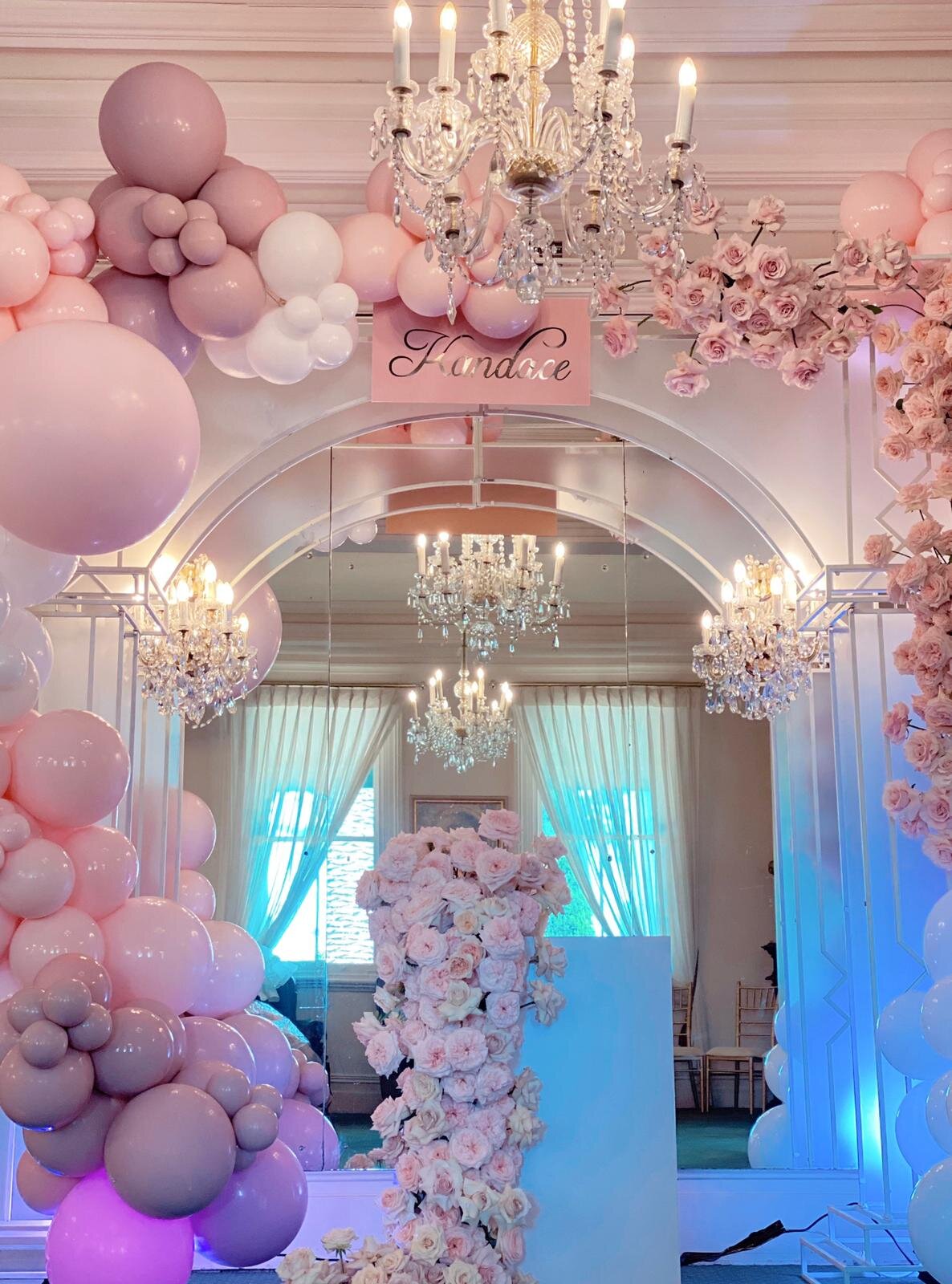 pink and white balloons and flowers backdrop 