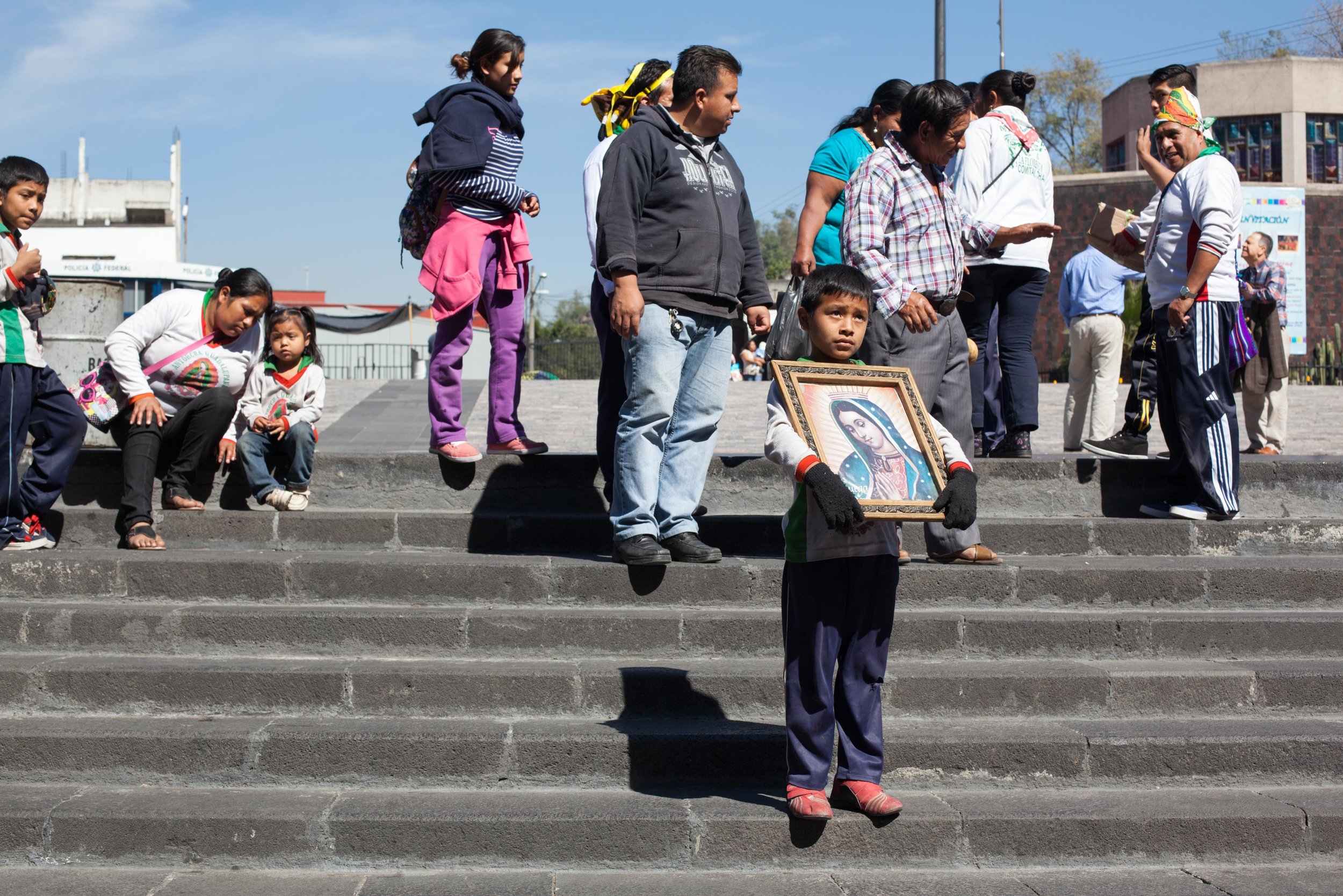 A young boy holds a picture of the the Basilica of Our Lady of Guadalupe in Mexico City 