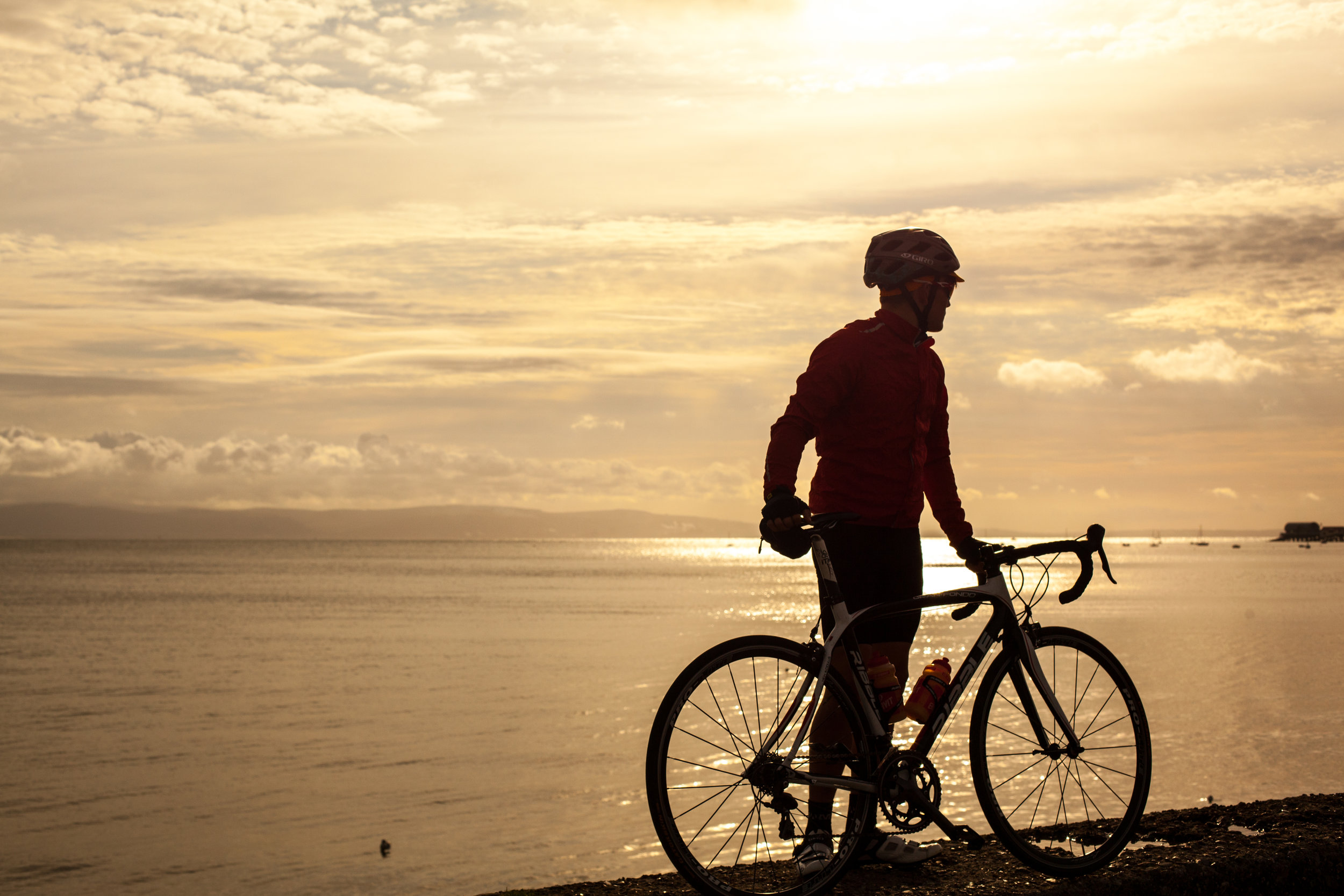 Welsh cyclist William Morgan at sun rise at the Mumbles in Swansea.