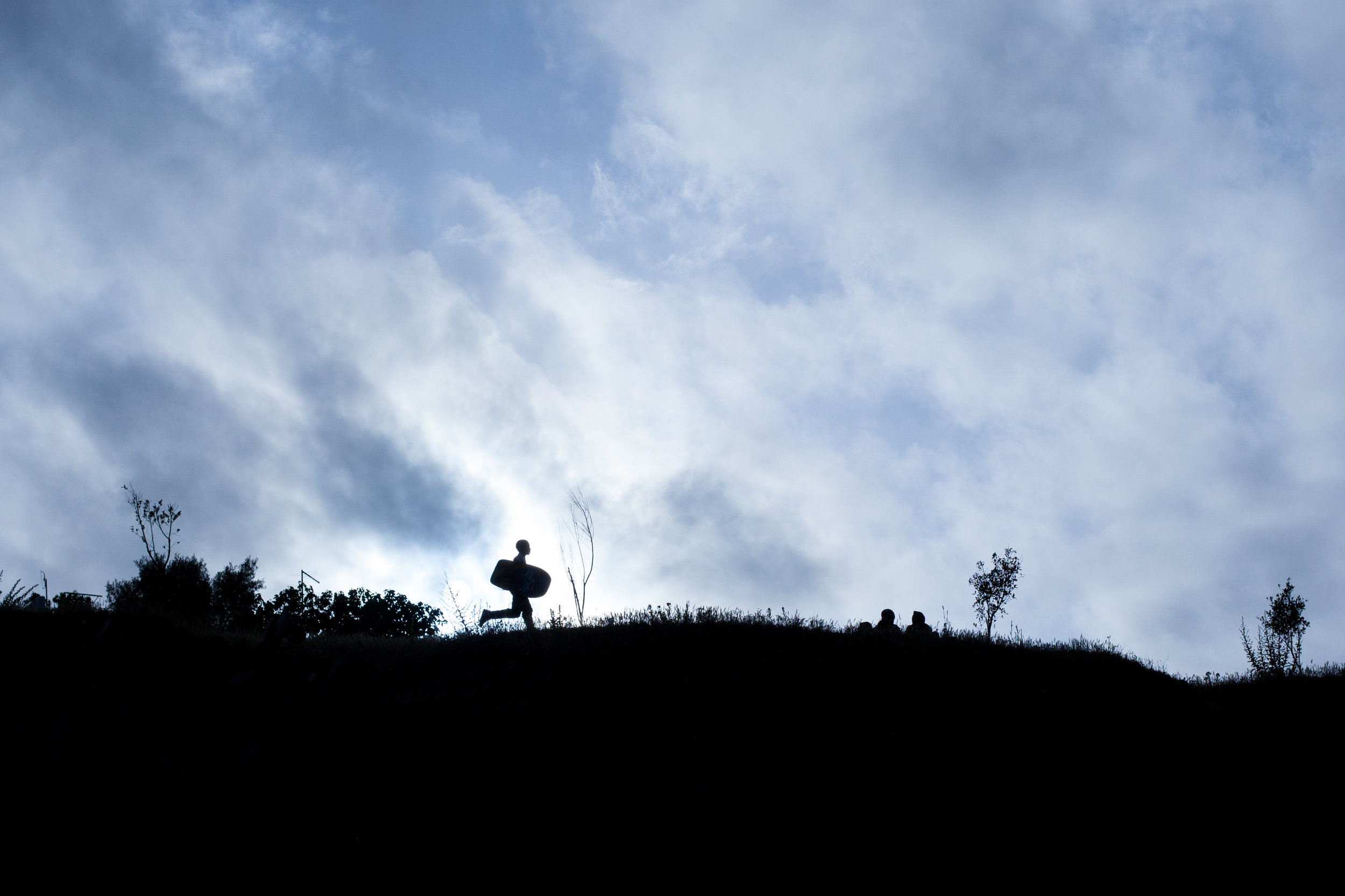 A silhouette photo of a body boarder in Morocco.