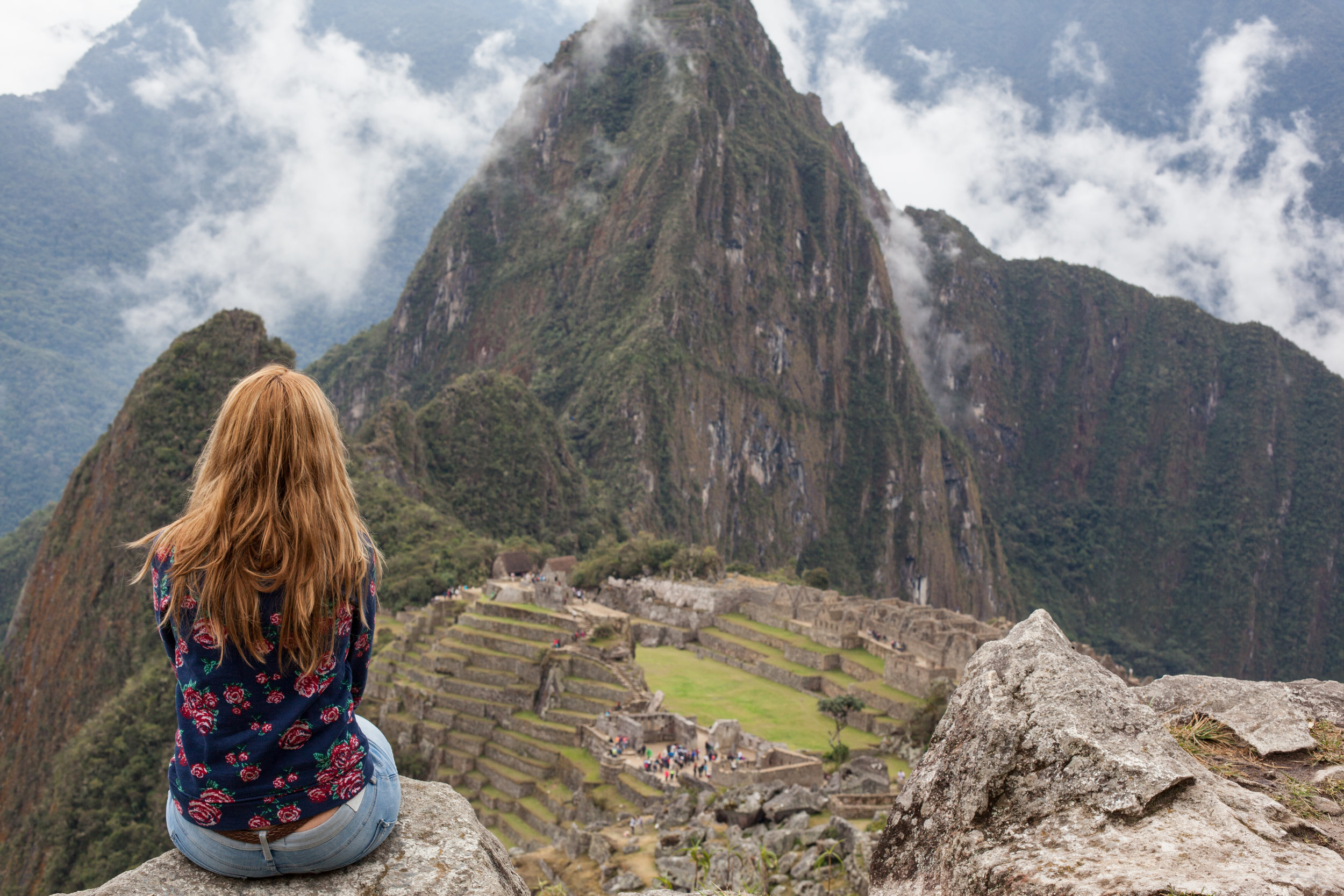 A solo female traveller enjoying Machu Picchu.