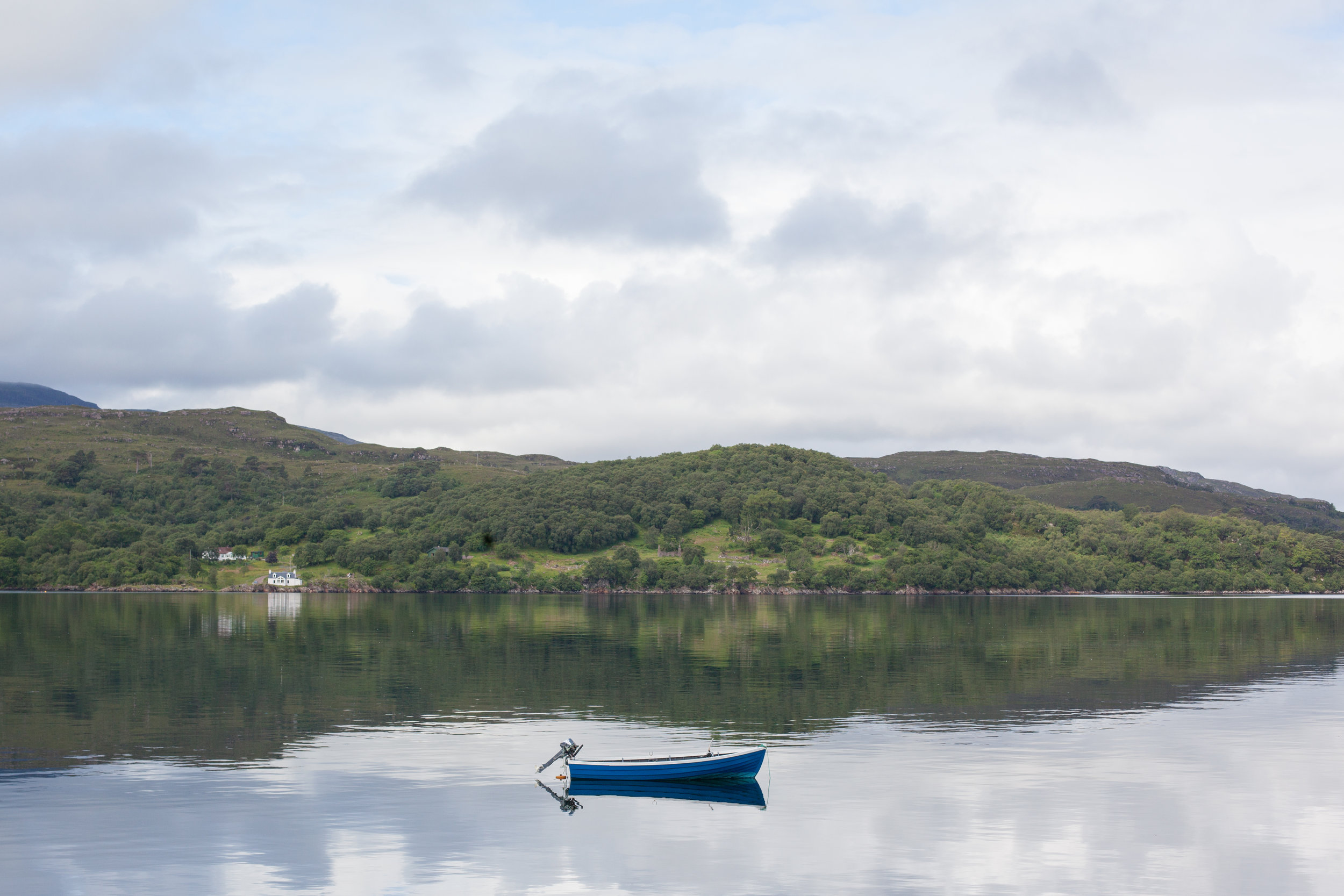 A small boat in this tranquil photo in Scotland.