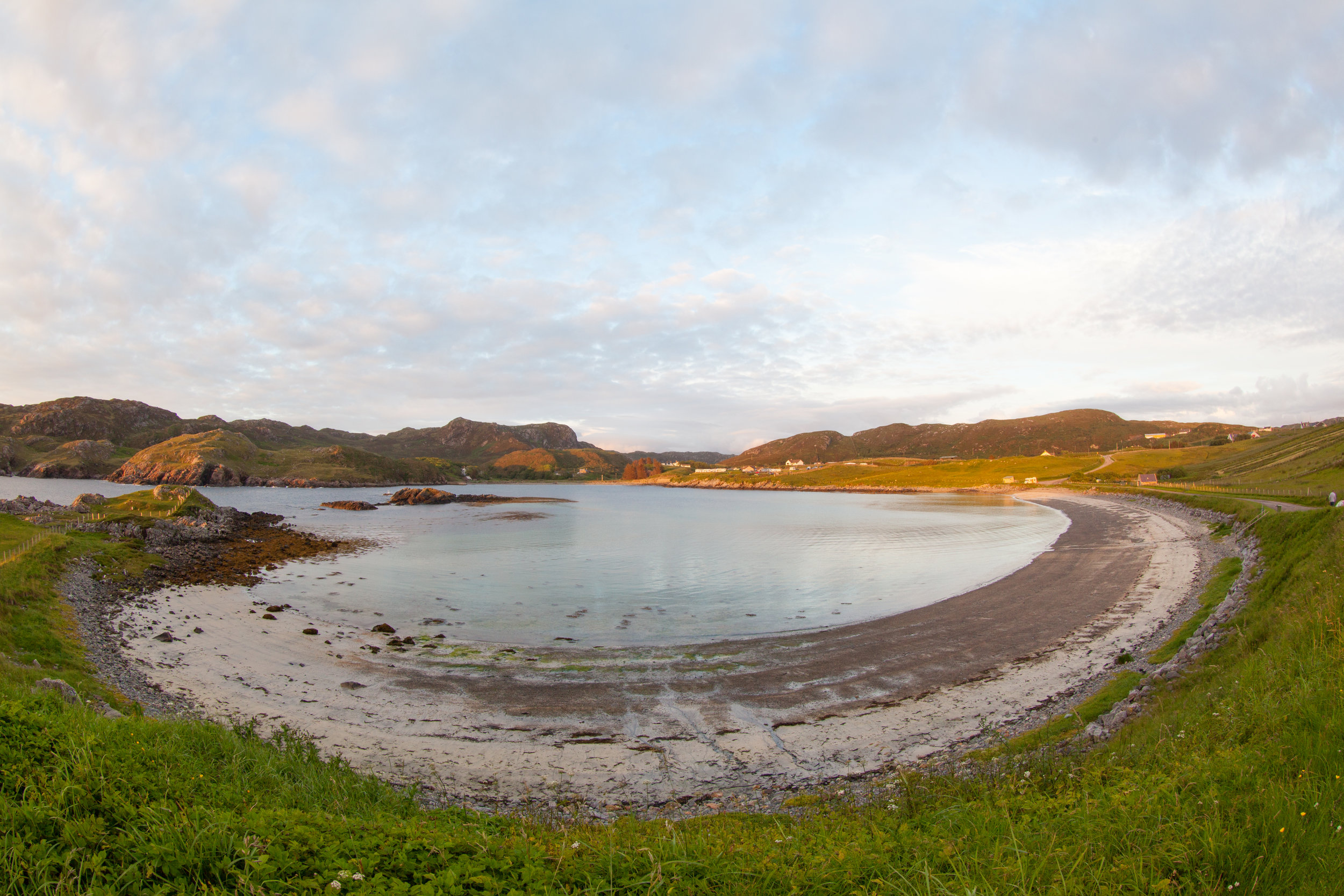 A fish eye capture of a circular beach in Scotland.