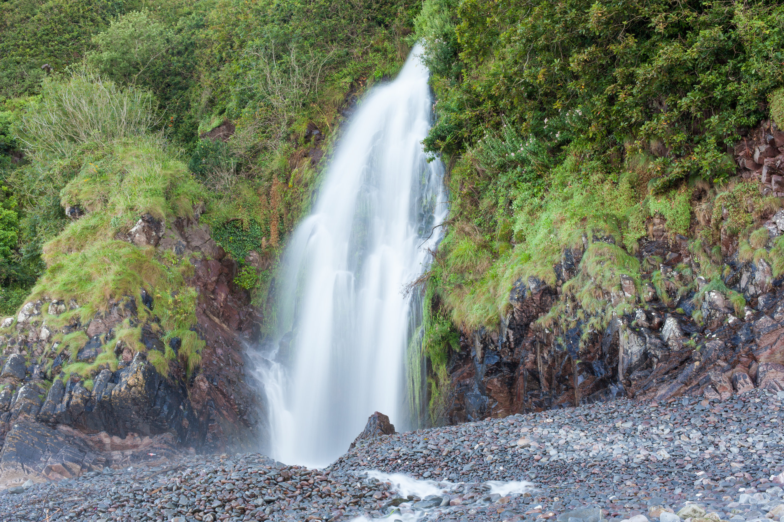 A waterfall at Clovelly Beach in Devon.