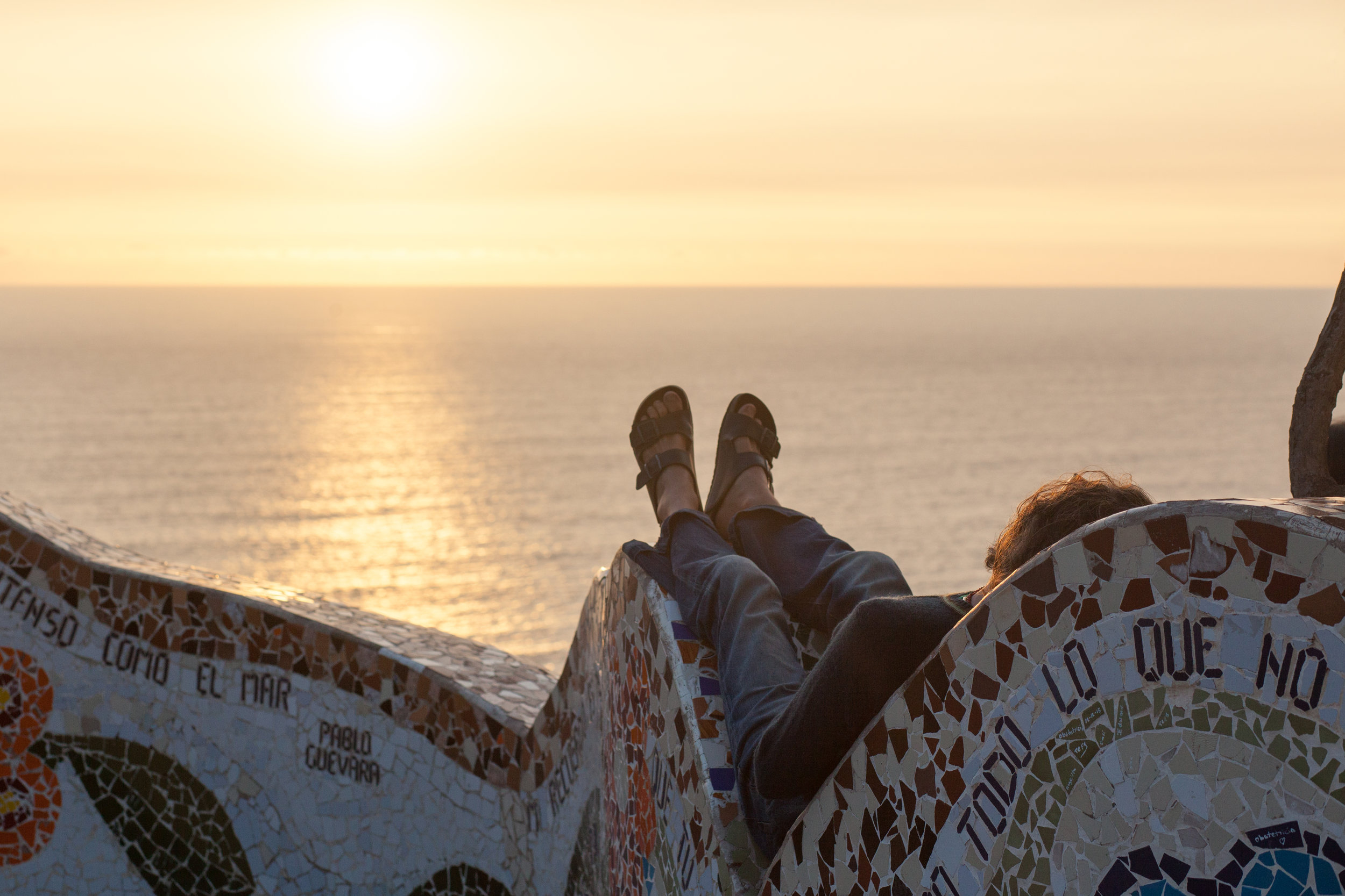 A man enjoys the setting sun in lovers Park in Miraflores, Peru.