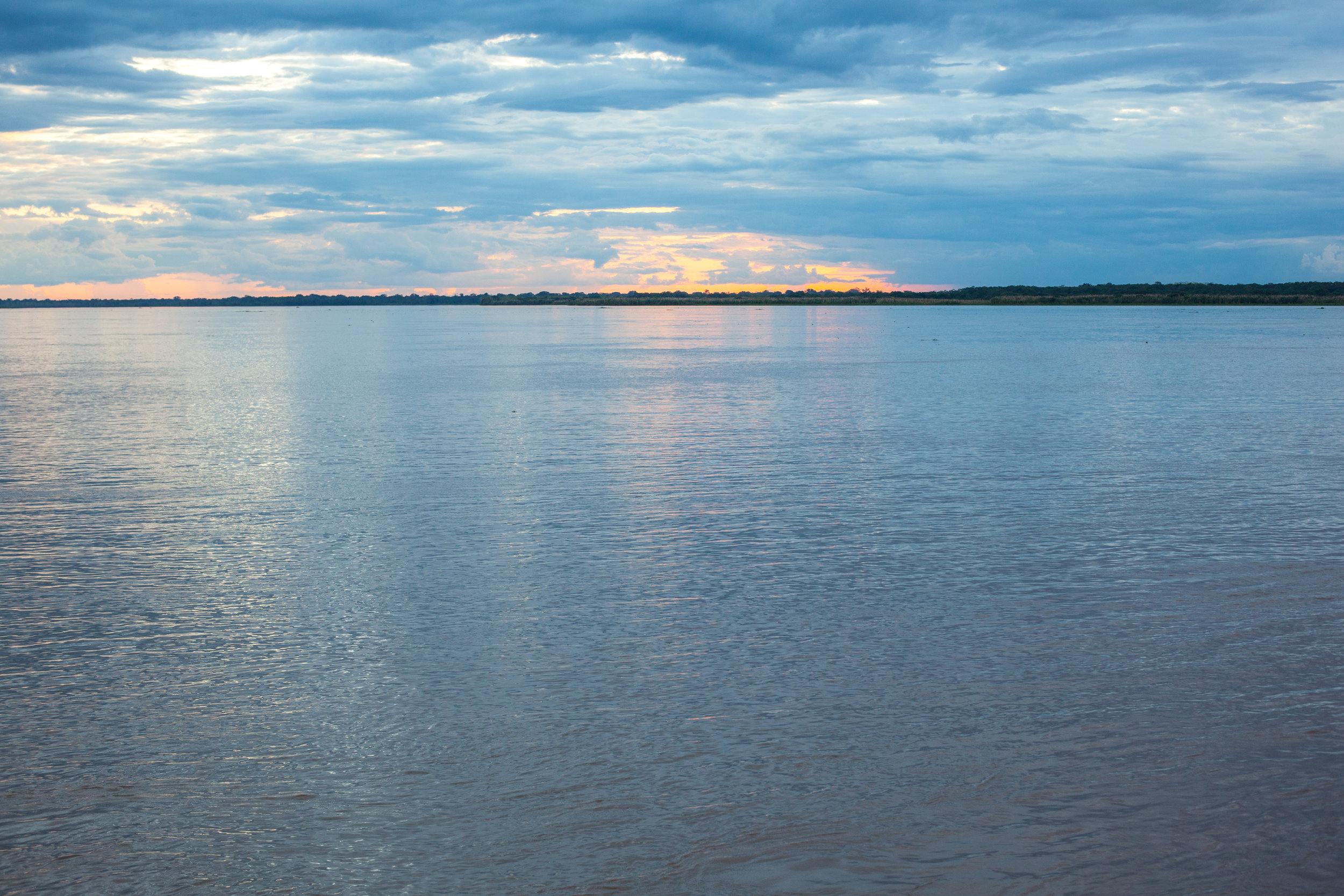 A calming photo of the Amazon river in Peru at sunset.