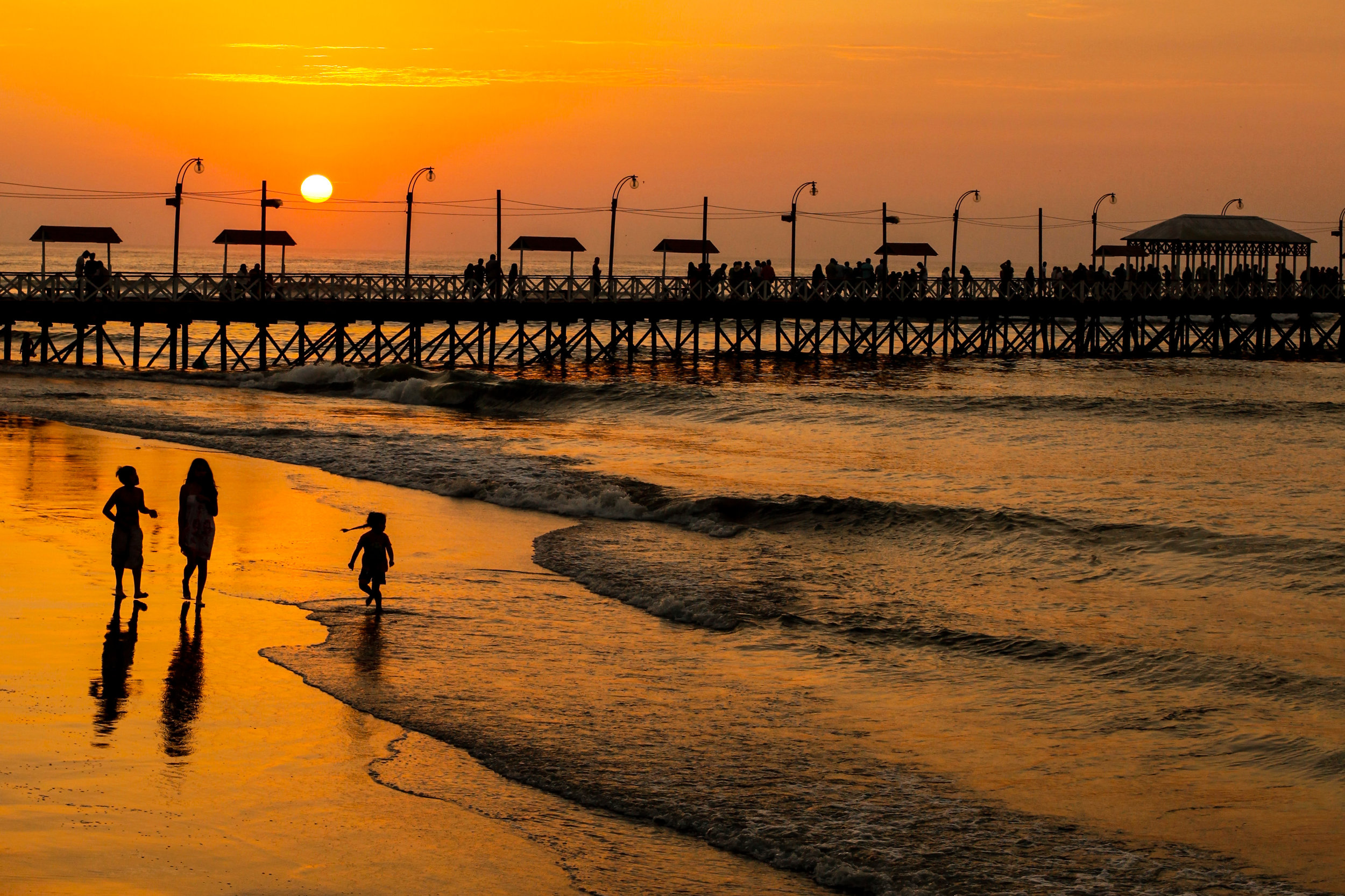 Golden sunset over the pier in Huanchaco, Trujillo, Peru.