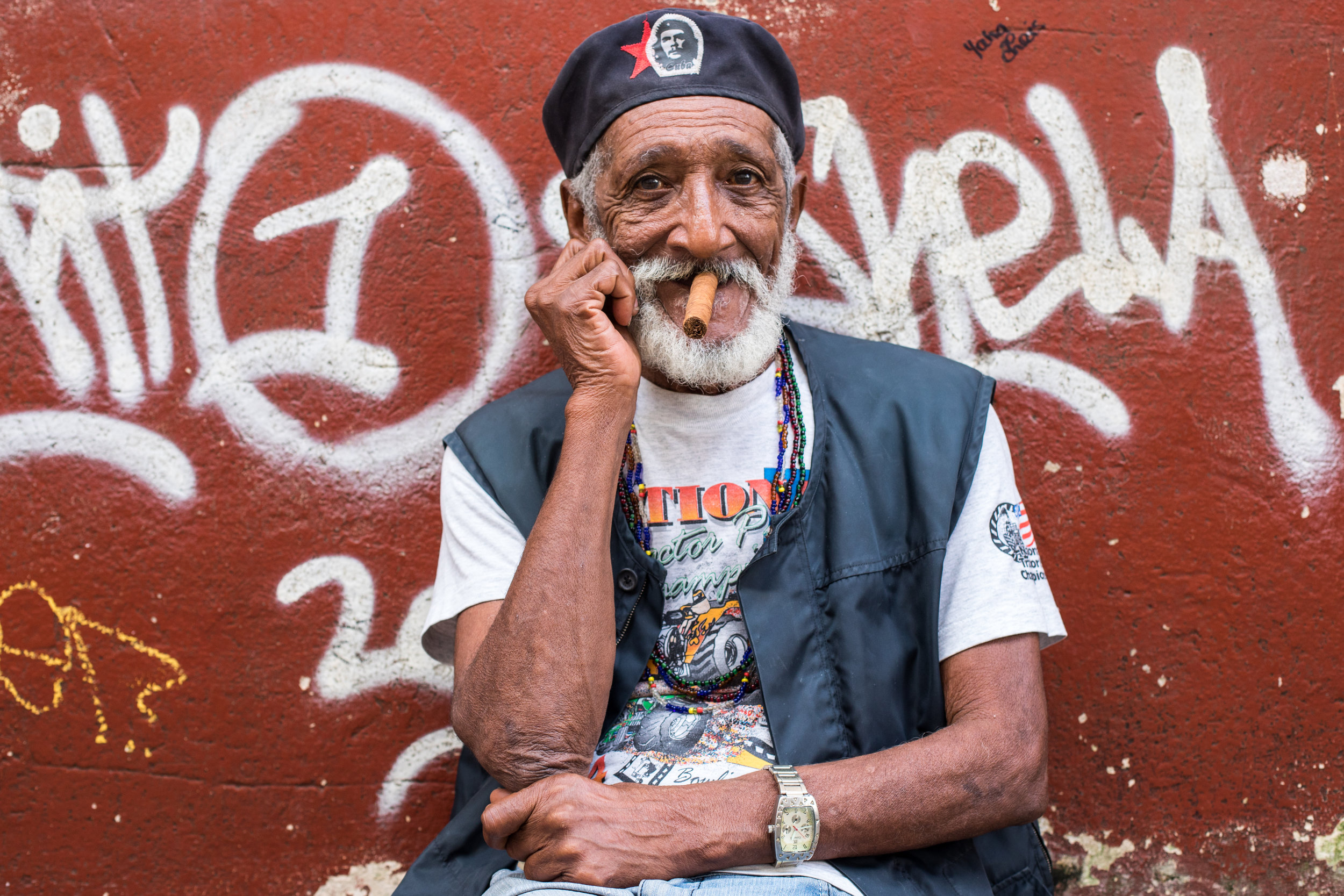 A man dressed as Cuban hero Che Guevara smokes a local cigar on the streets of Havana.