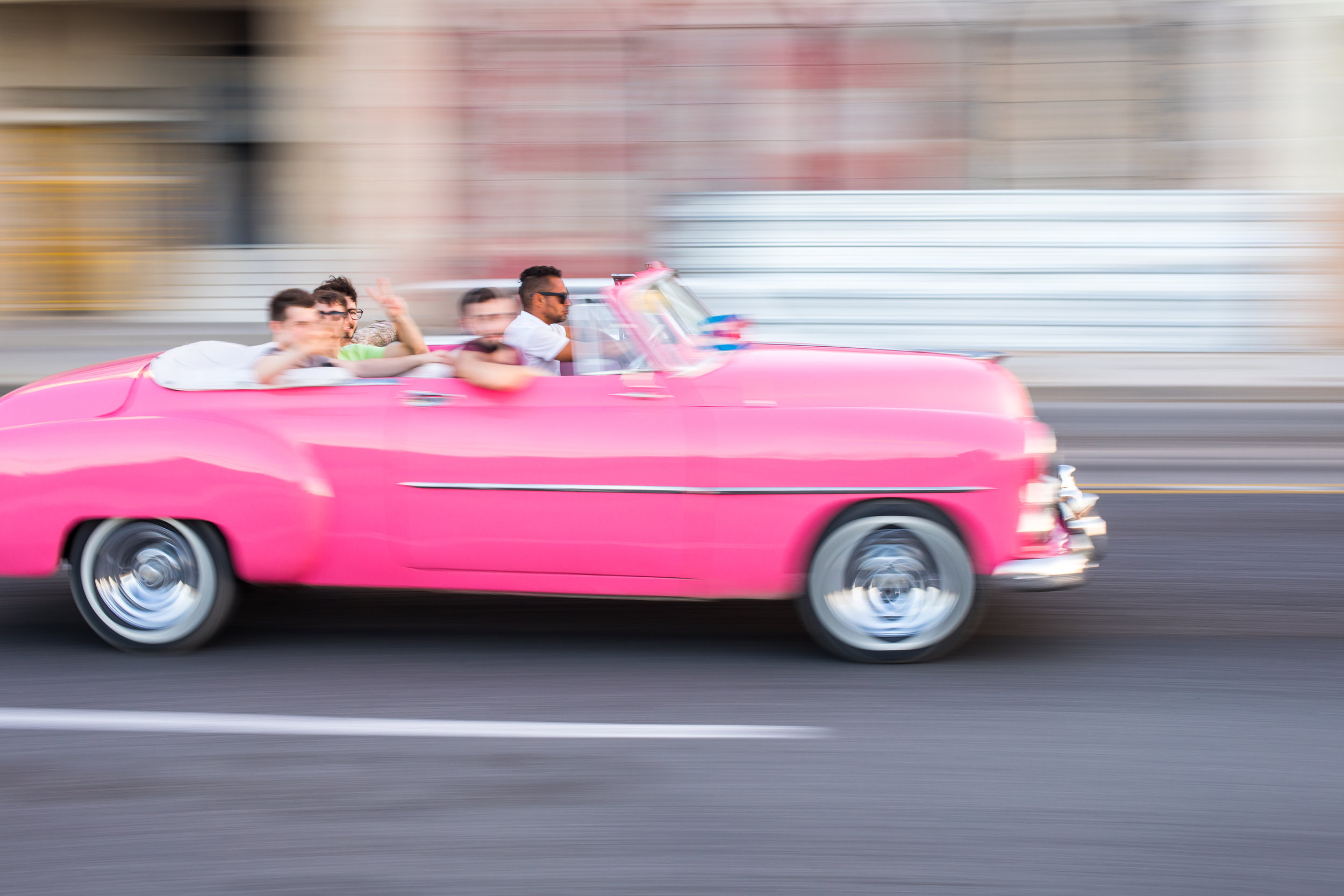 A example of the panning technique in photography with a pink classic car in Cuba.