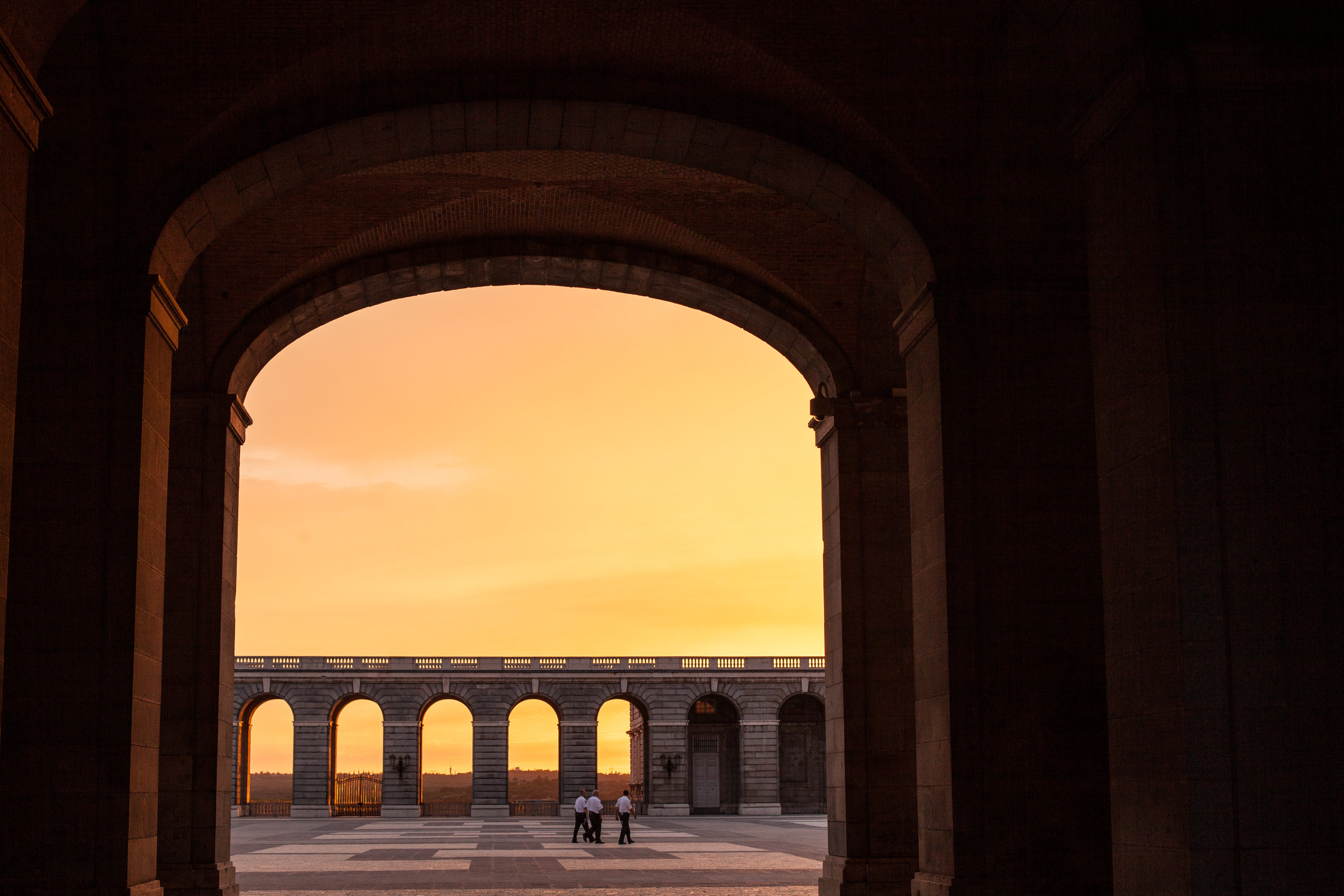 A frame within a frame, a sunset viewed through the archway of the palace in Madrid.