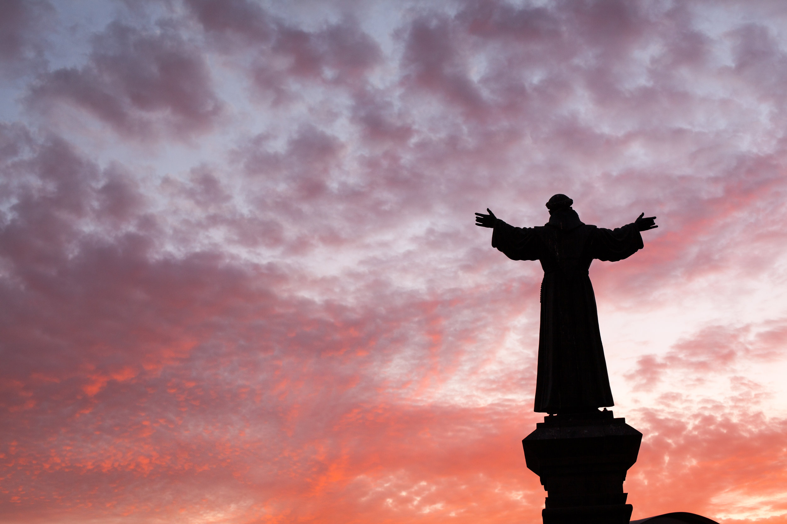 Negative space can add drama to an image such as this religious statue against a blood red sunset in Arequipa, Peru.