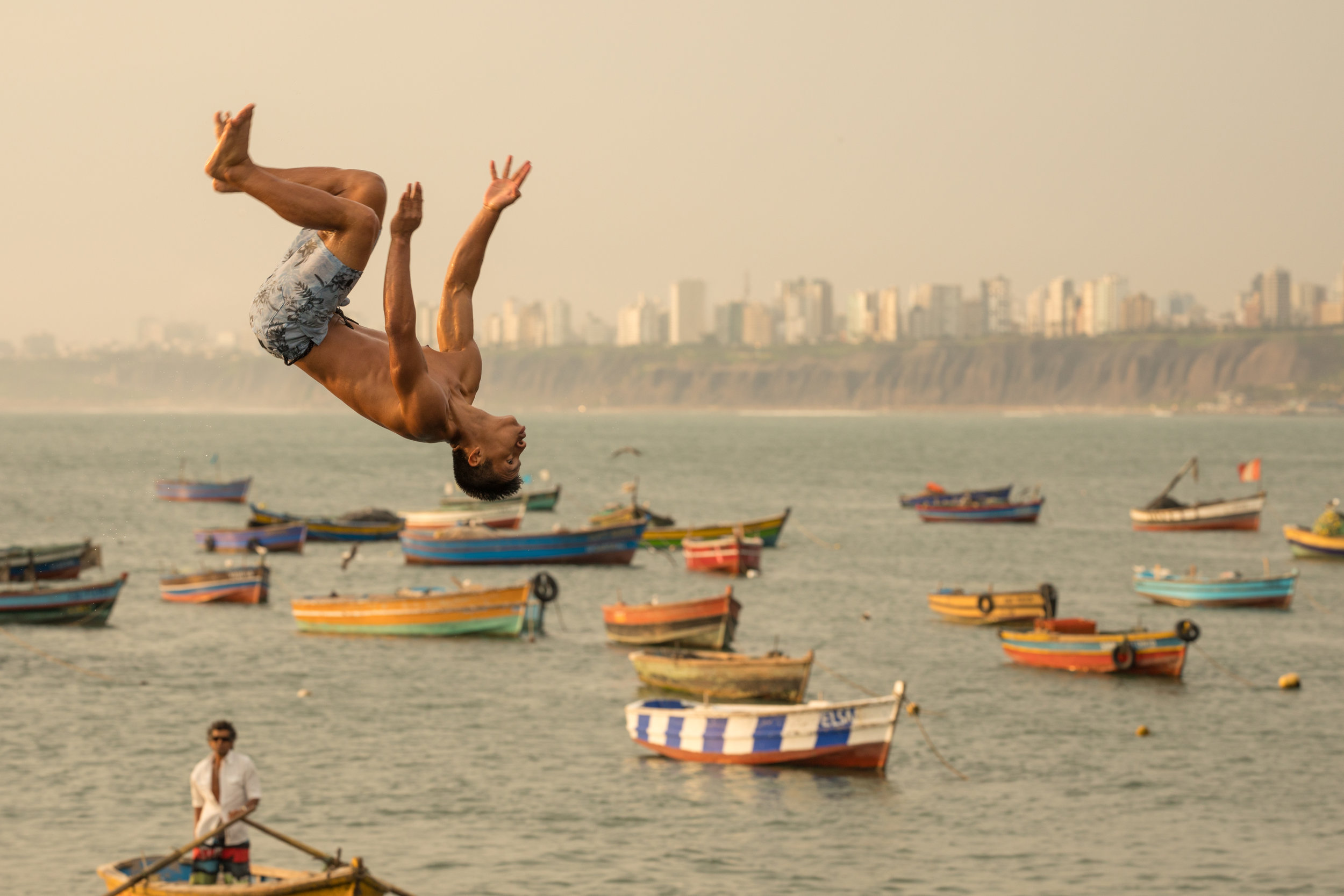 Ffotogallery Platform Instagram Takeover by Geraint Rowland - A boy backflips into the Ocean in Chorillos, Lima, Peru.