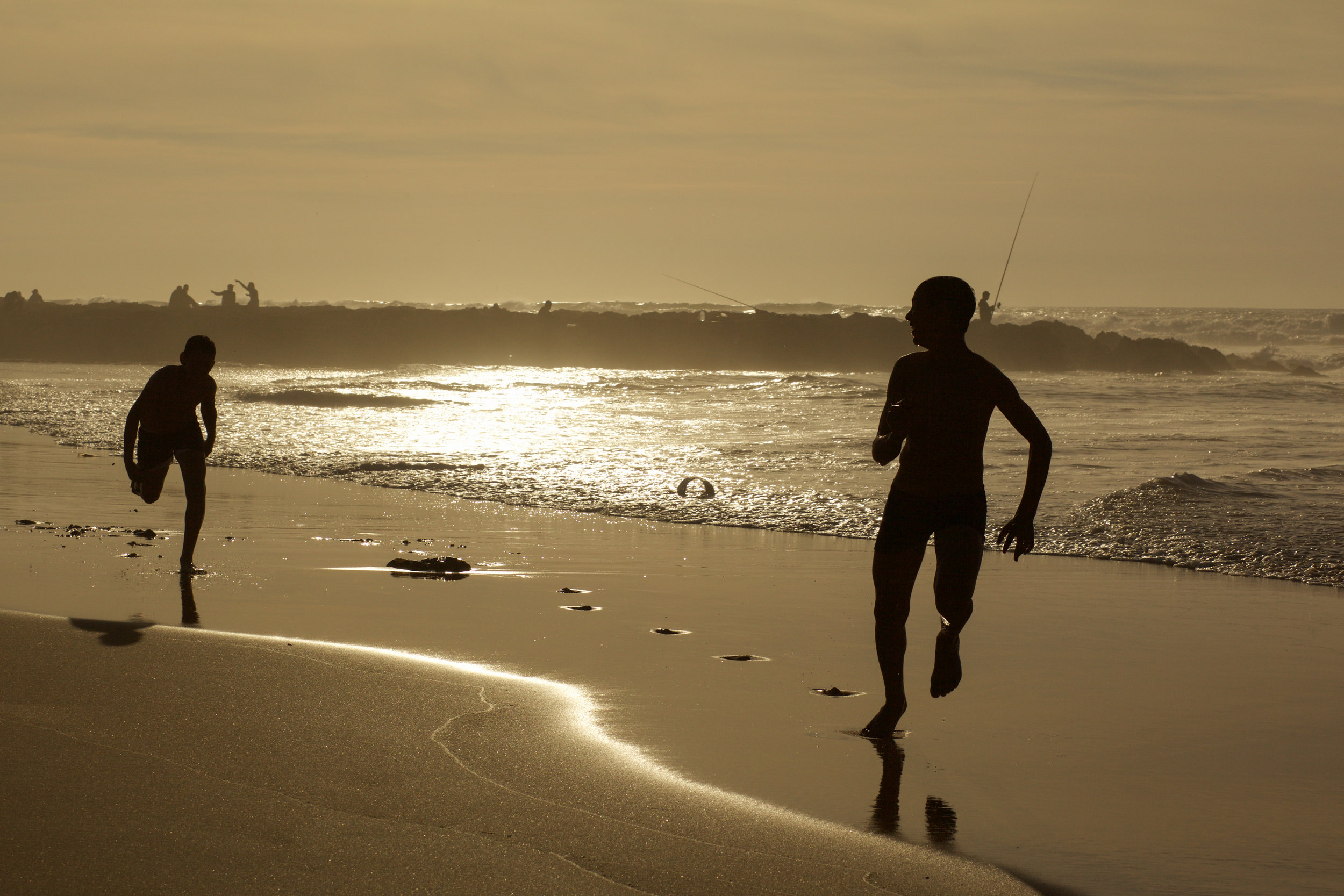 Locals playing on the beach at Casablanca while the sun sets.  A silhouette style image.