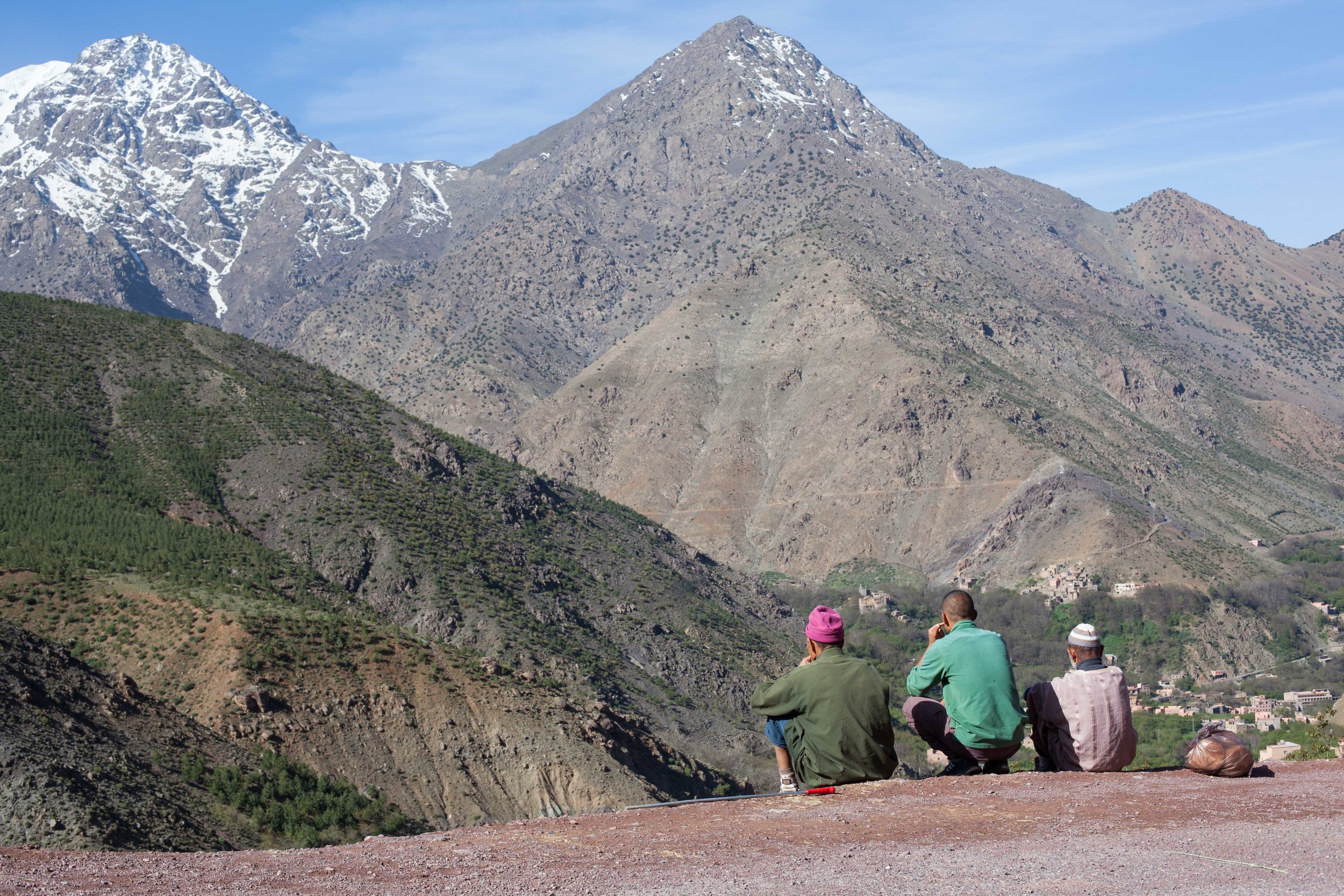 Berbers, are an ethnic group indigenous to North Africa.  Three locals enjoying the view from their backyard in the Atlas Mountains.