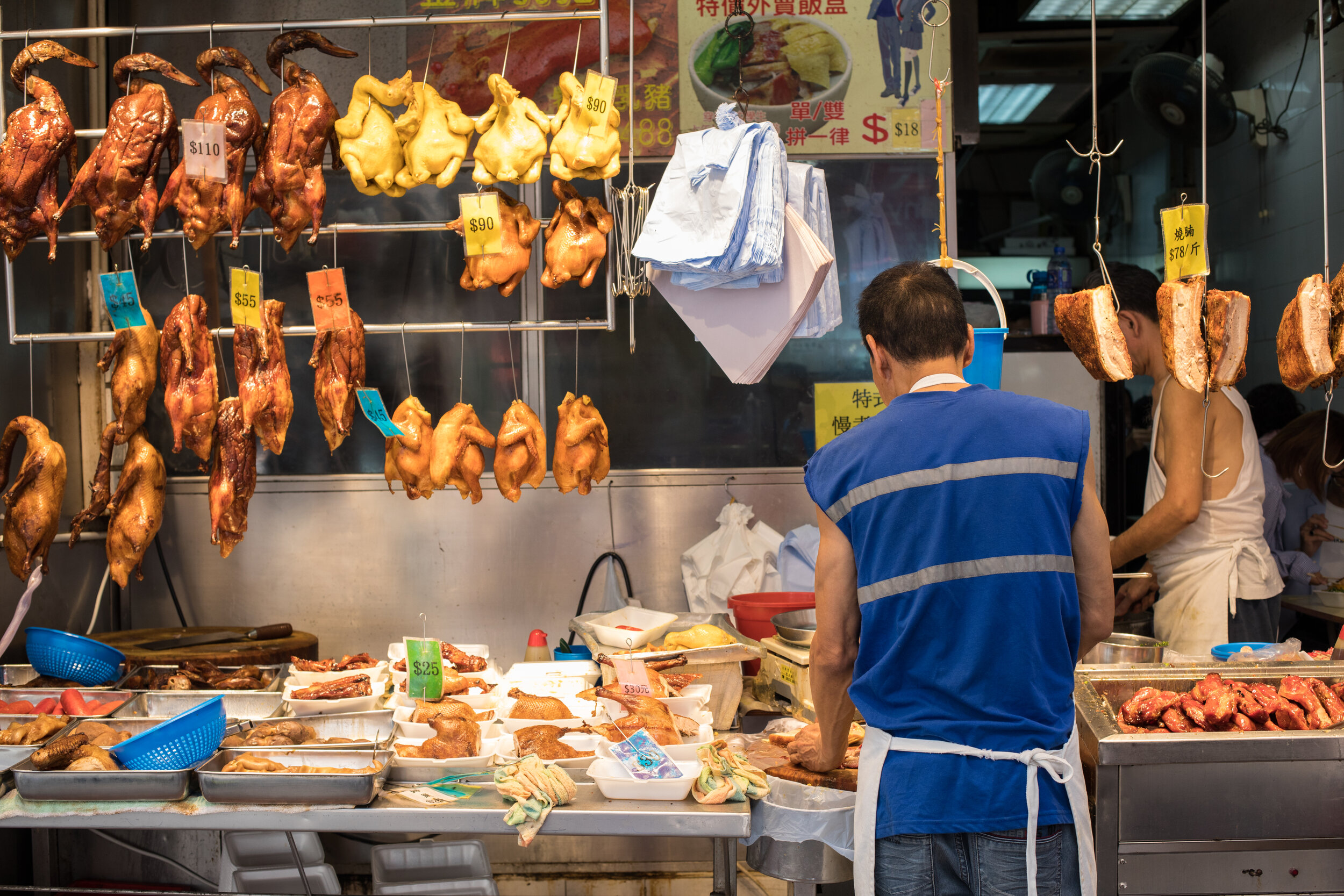 Food preparation and sale at a store in Hong Kong.
