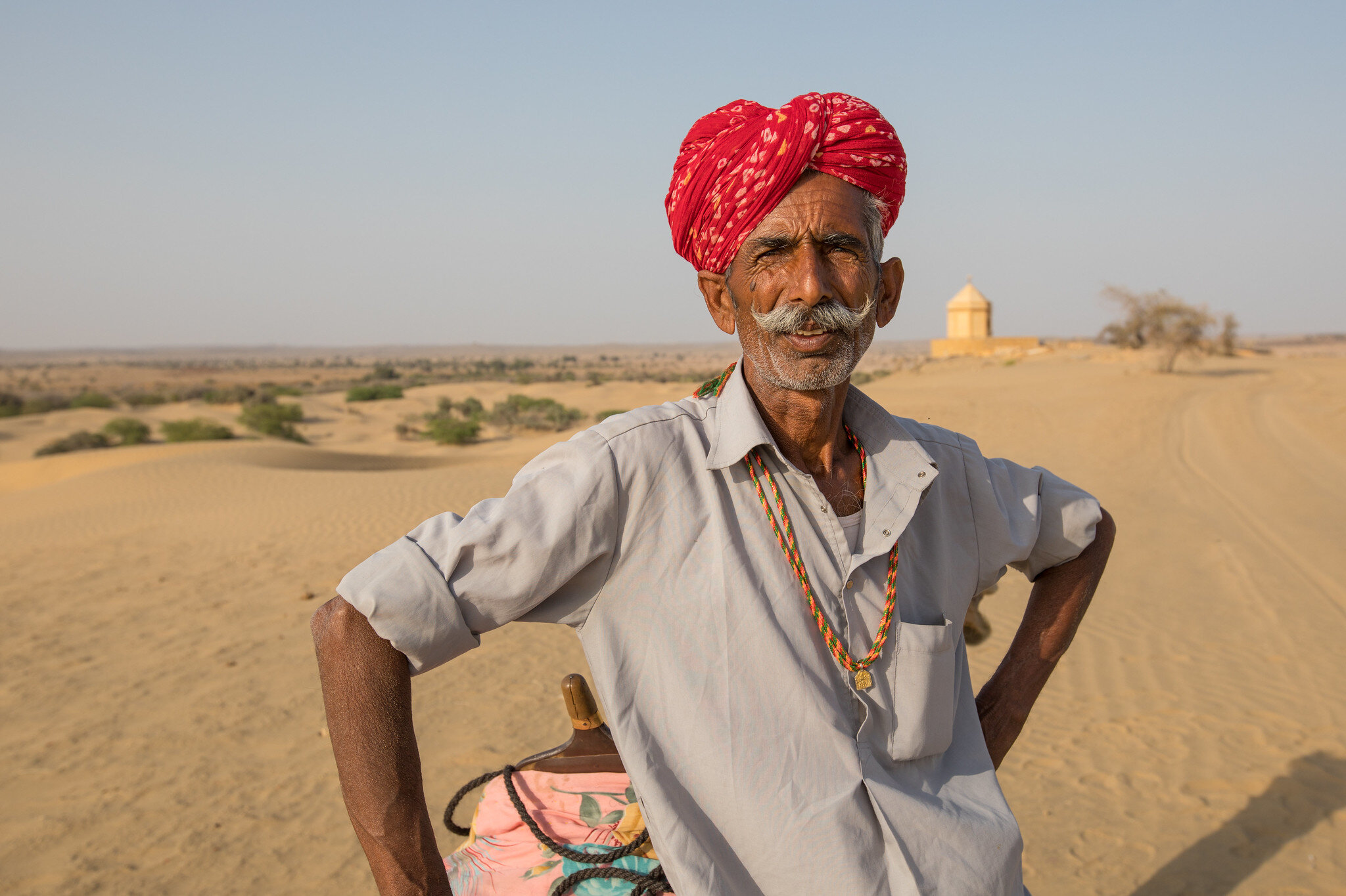 A Camel herder poses for a photo in the Thar Desert.