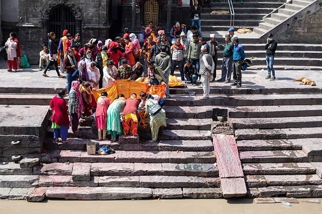 Public cremations take place by the river at the Pashupatinath Temple in the city of Kathmandu, Nepal. 
Women gather around a cremation ready body for one last goodbye.

More of my travel images can be found on my website: 
www.geraintrowland.co.uk.
