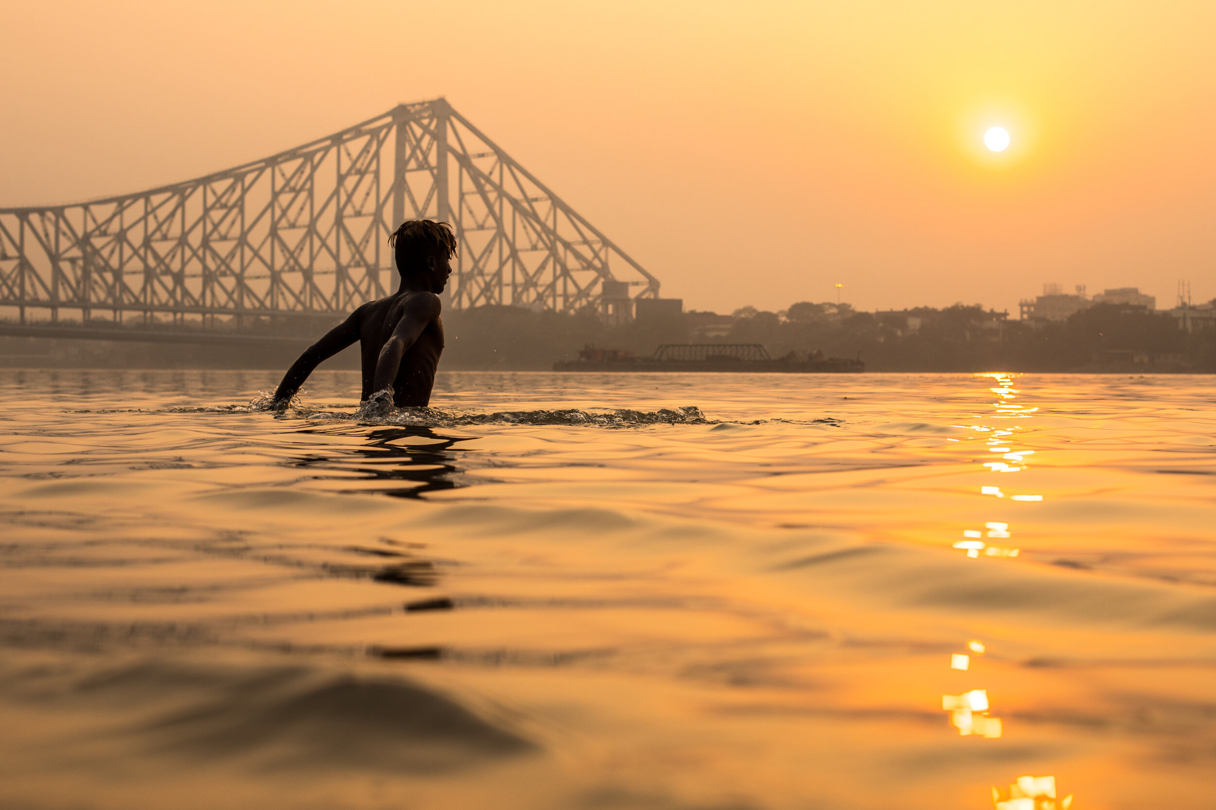 Bathing in the river at sunset, Calcutta, India.