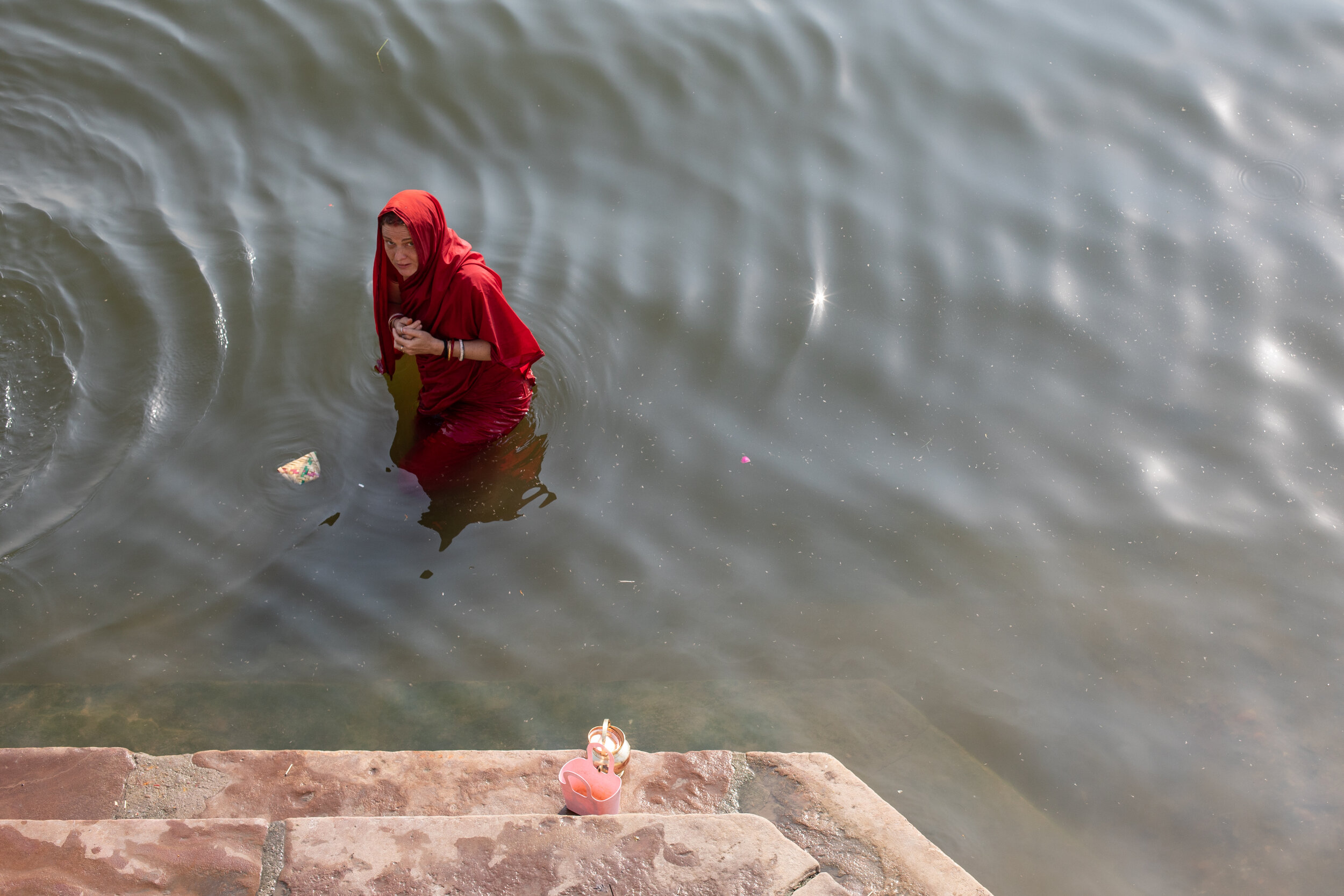 A woman bathes clothed in the Holy River Ganges in India.