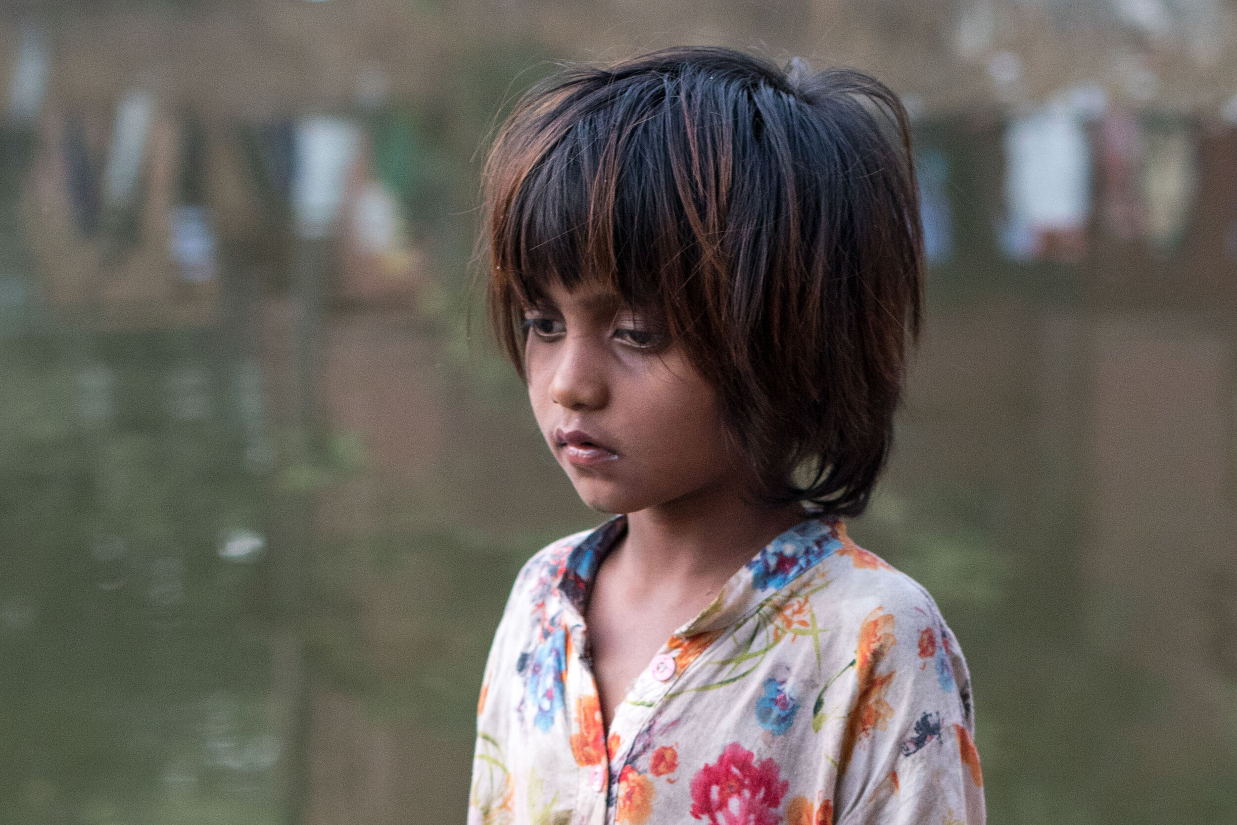 Candid portrait of a sad looking girl in Dhaka, Bangladesh.