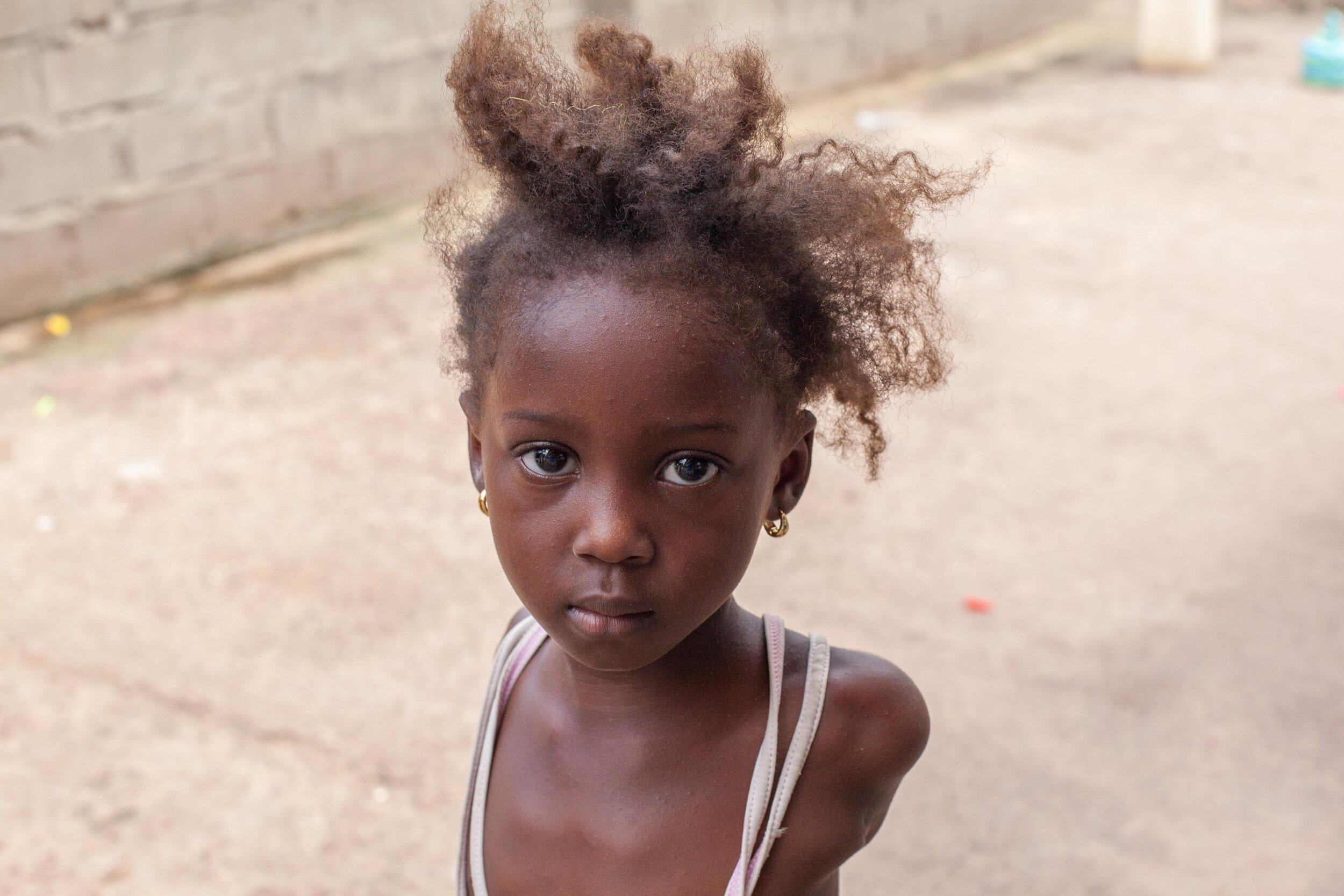 Street portrait of a young girl in The Gambia.