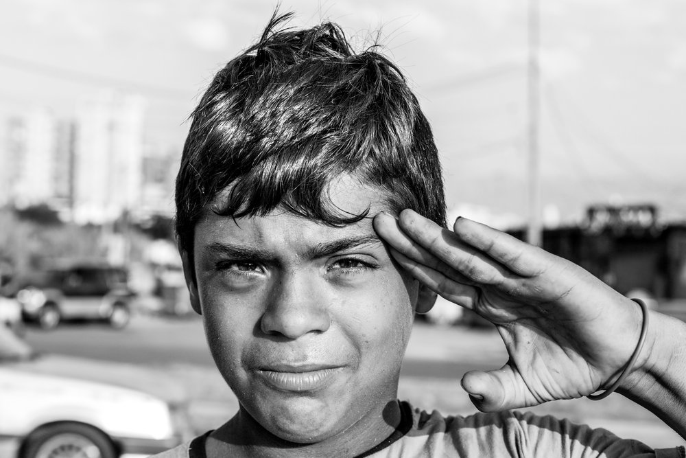 Street portrait of a confident child on the seafront of Tripoli in Lebanon