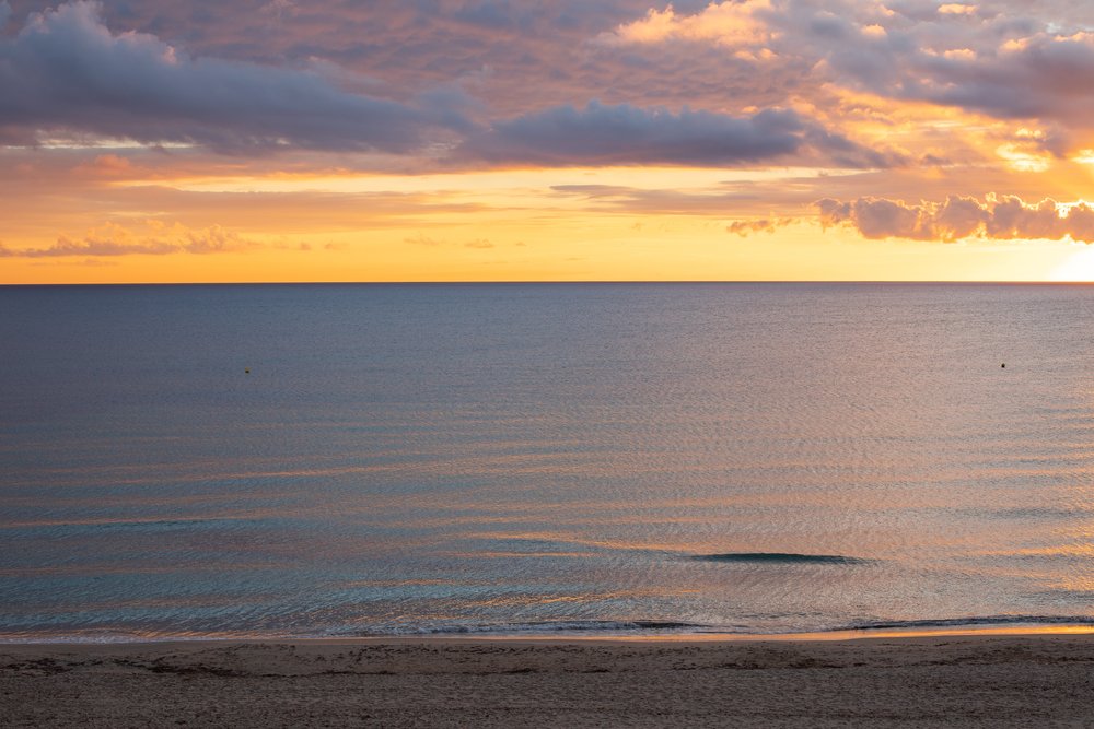 Sunrise over the Mediterranean Sea on the beach at Mil Palmeras