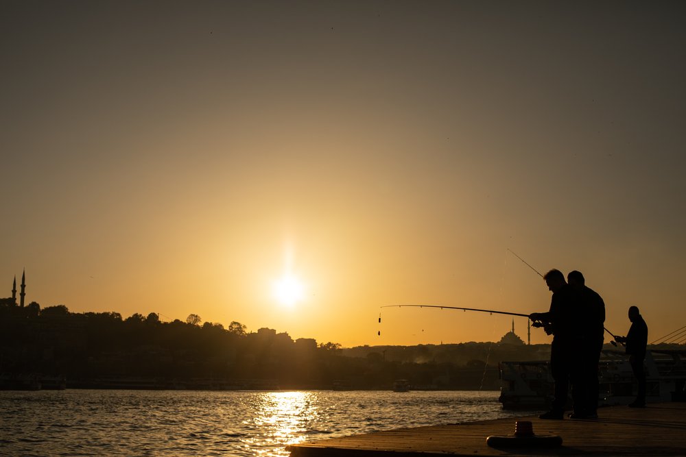Fishermen at sunset on the Bosphorus in Istanbul