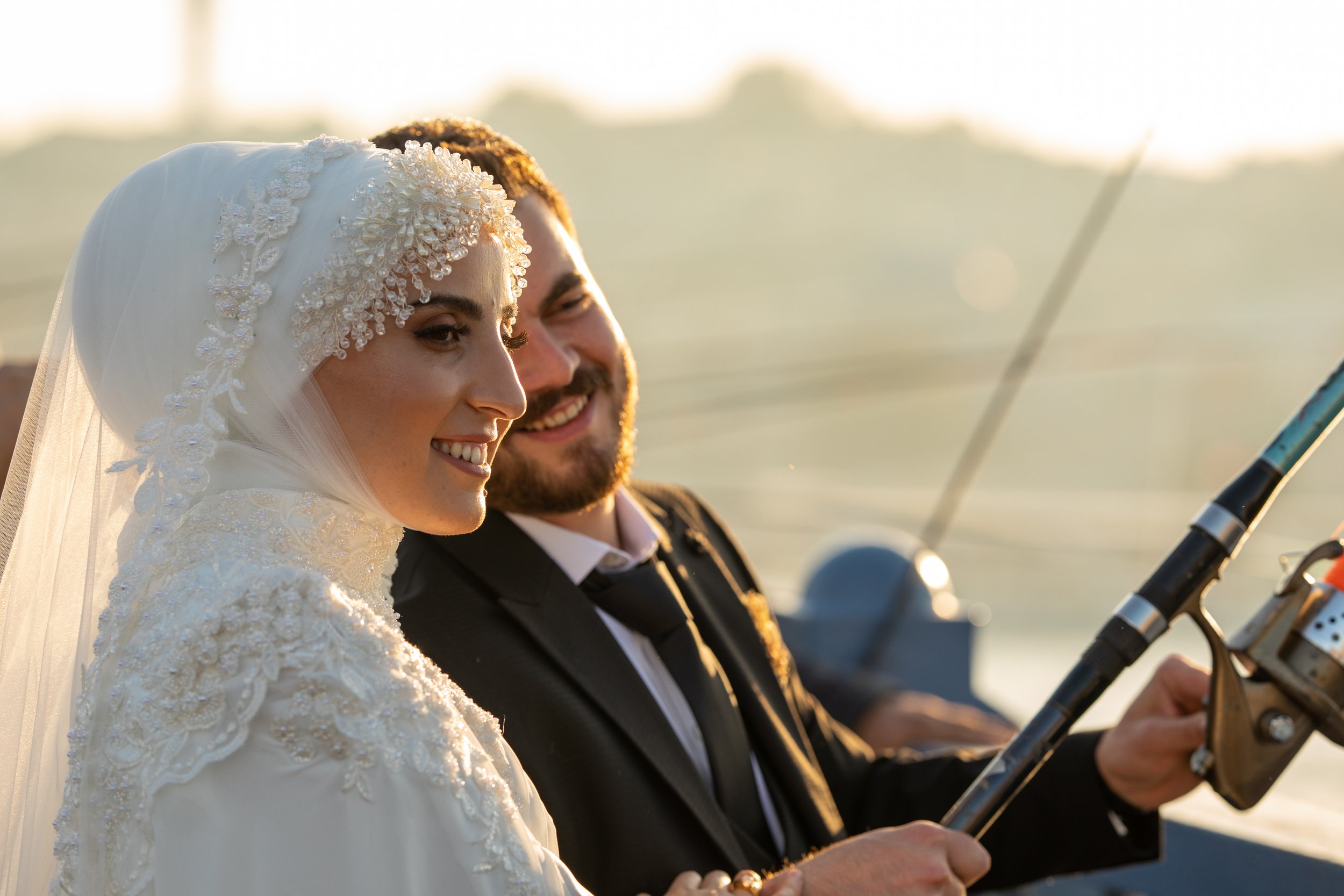 Newlyweds pose for a photo on a bridge over the Bosphorus