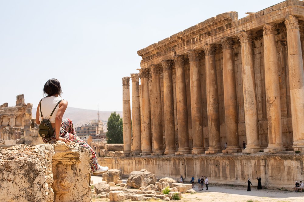 A tourist sits and enjoys the impressive ruins at Baalbek in Lebanon.