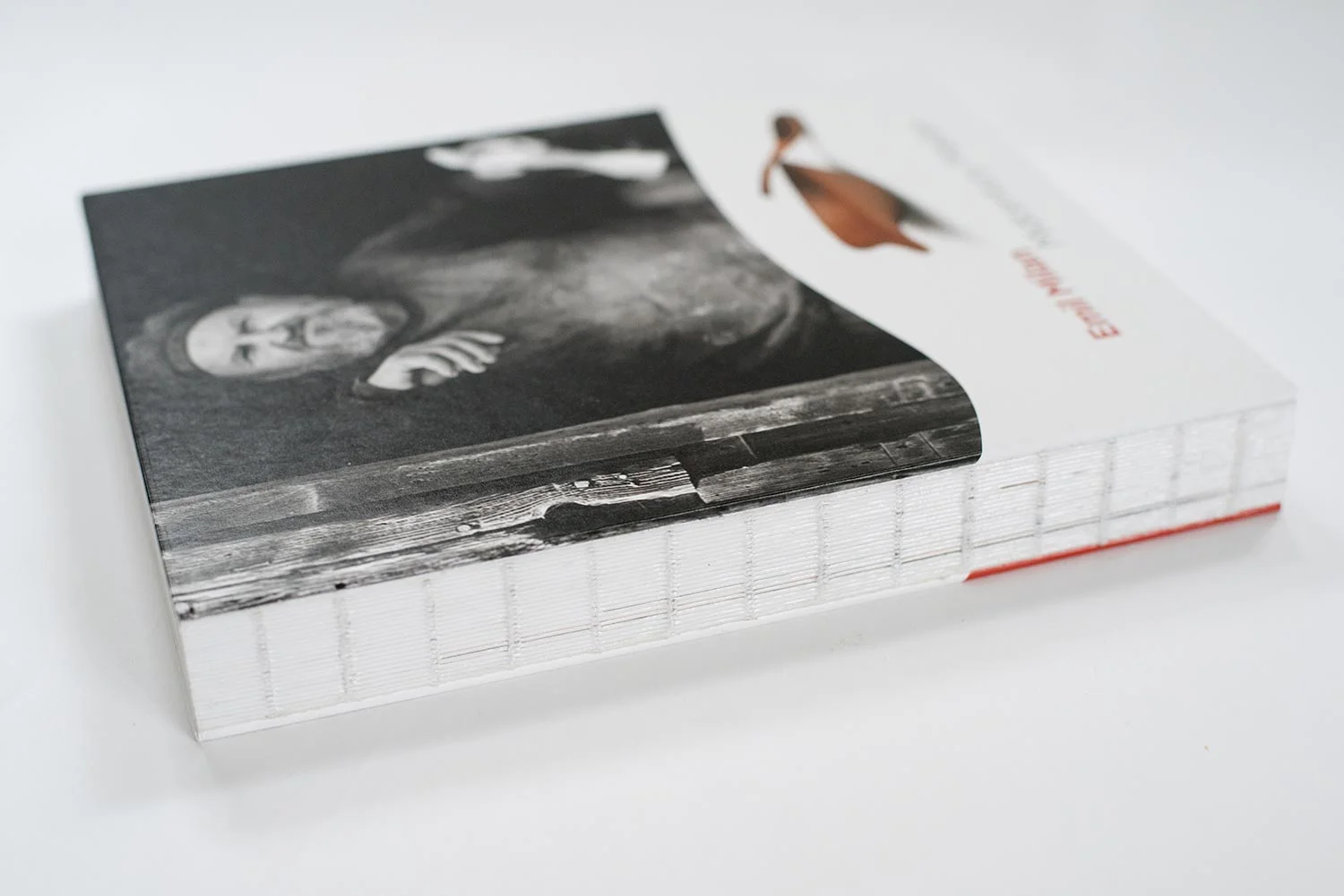 Exposed, thread-sewn binding that allows the book to lay virtually flat