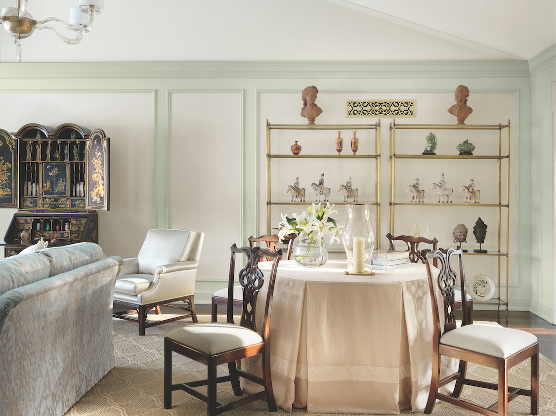 Picture frame molding surrounds the 18th century chinoiserie secretary and a collection of antiquities from around the world. 