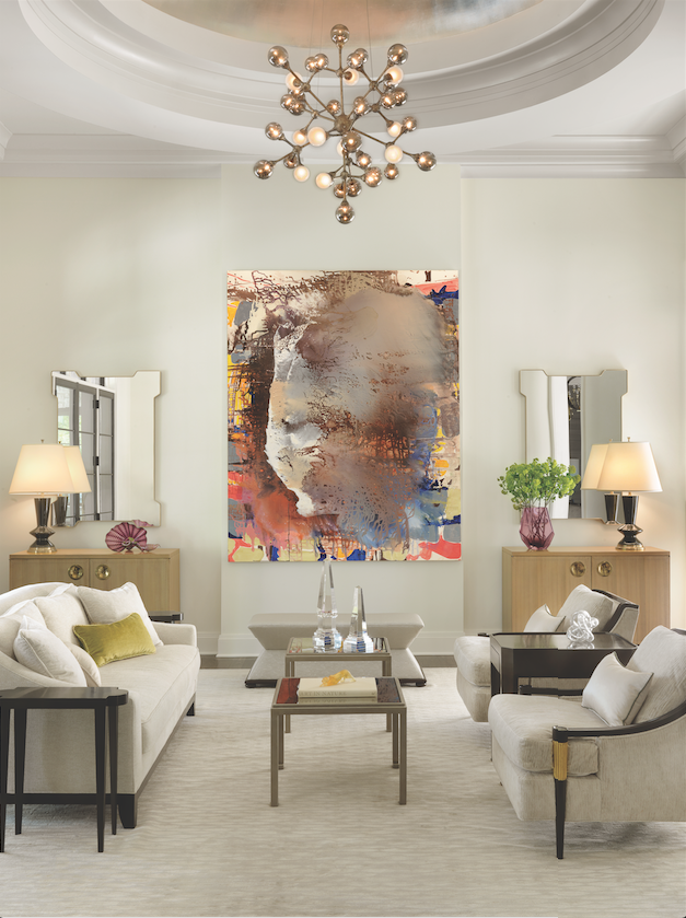 A silken Tufenkian rug and neutral furnishings are awash in natural light from nearby French doors, enhanced by a domed ceiling shimmering with hand-applied silver leaf.