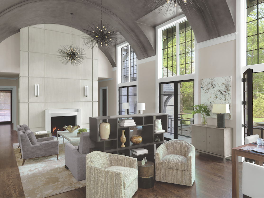 Proof that neutrals can be dramatic. The barrel-ceilinged gathering room, with a conversation grouping, hidden television, and casual dining space, is the center of the home.