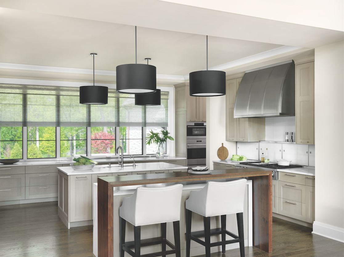 An abundance of deep drawers replaced upper cabinets in the kitchen, permitting abundant light to enter through ceiling-height windows.