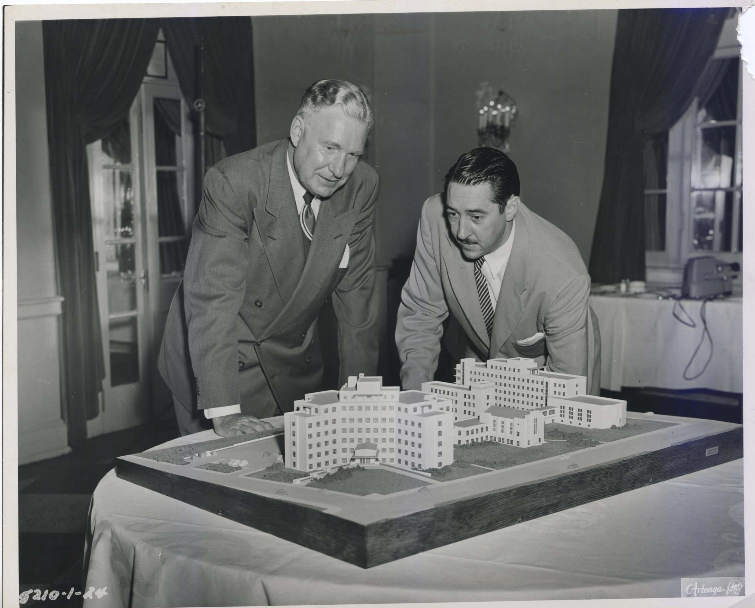 From the left, Leo Wieck and Dr. Peter Danis, two of the founders of the first Catholic Children’s Hospital in St. Louis, look at the tabletop model. The model was taken to each fundraising event. Photo provided by SSM Health Cardinal Glennon Children’s Foundation.